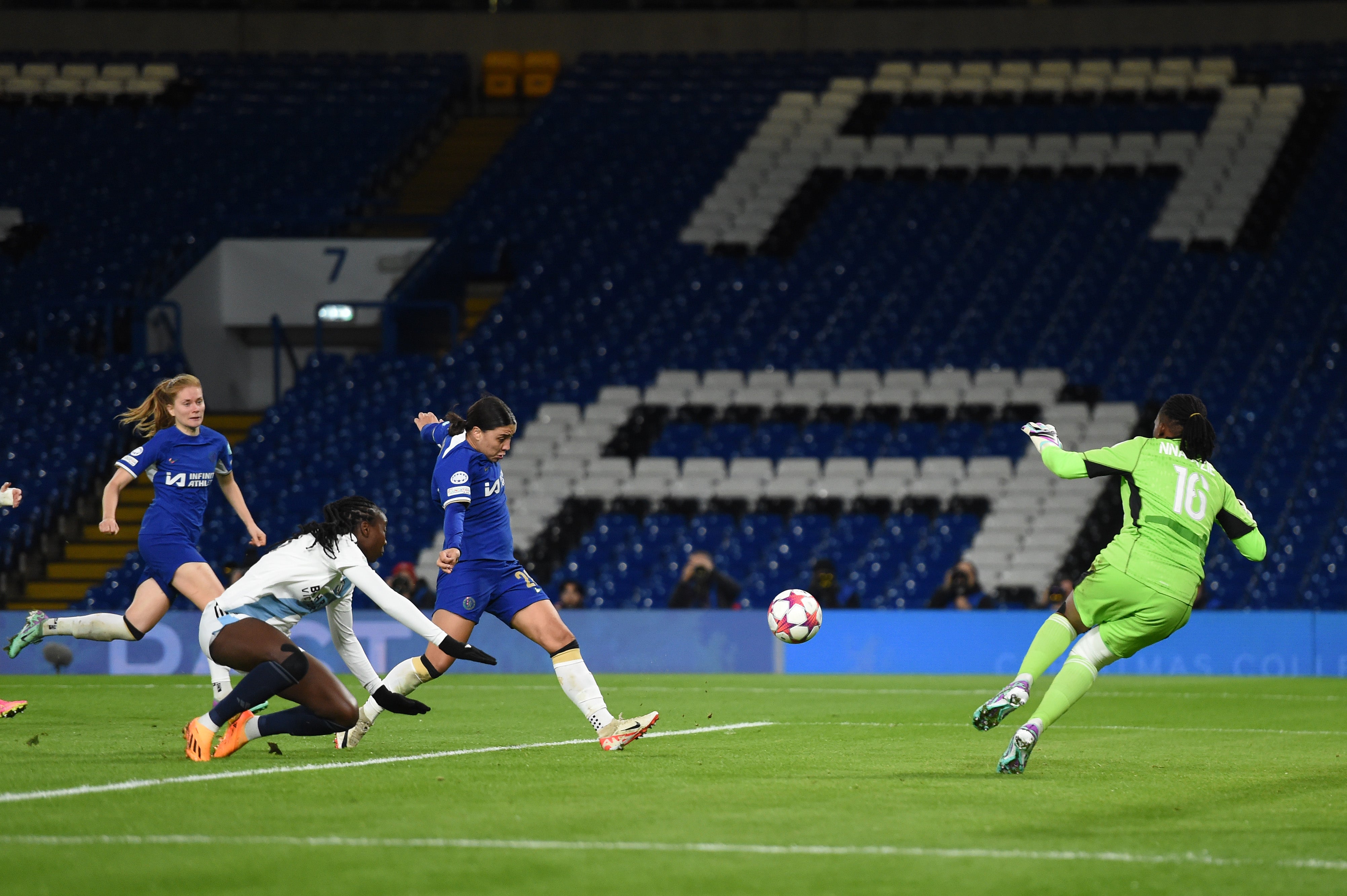 Sam Kerr chips Chiamaka Nnadozie to score her third goal of the night