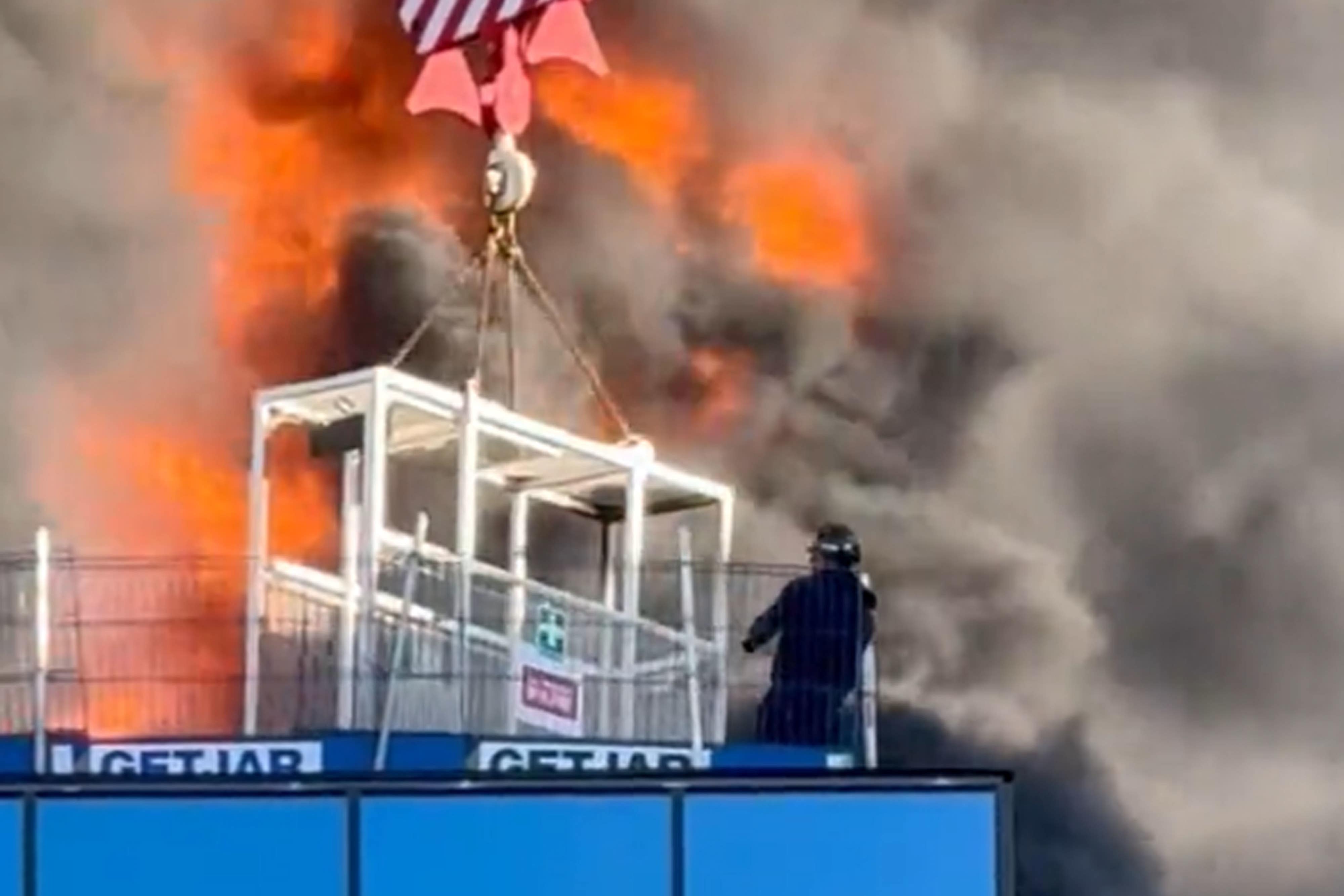 A workman was lifted to safety by a crane after a fire at a high-rise building in Reading (Chris Lauder/X/PA)