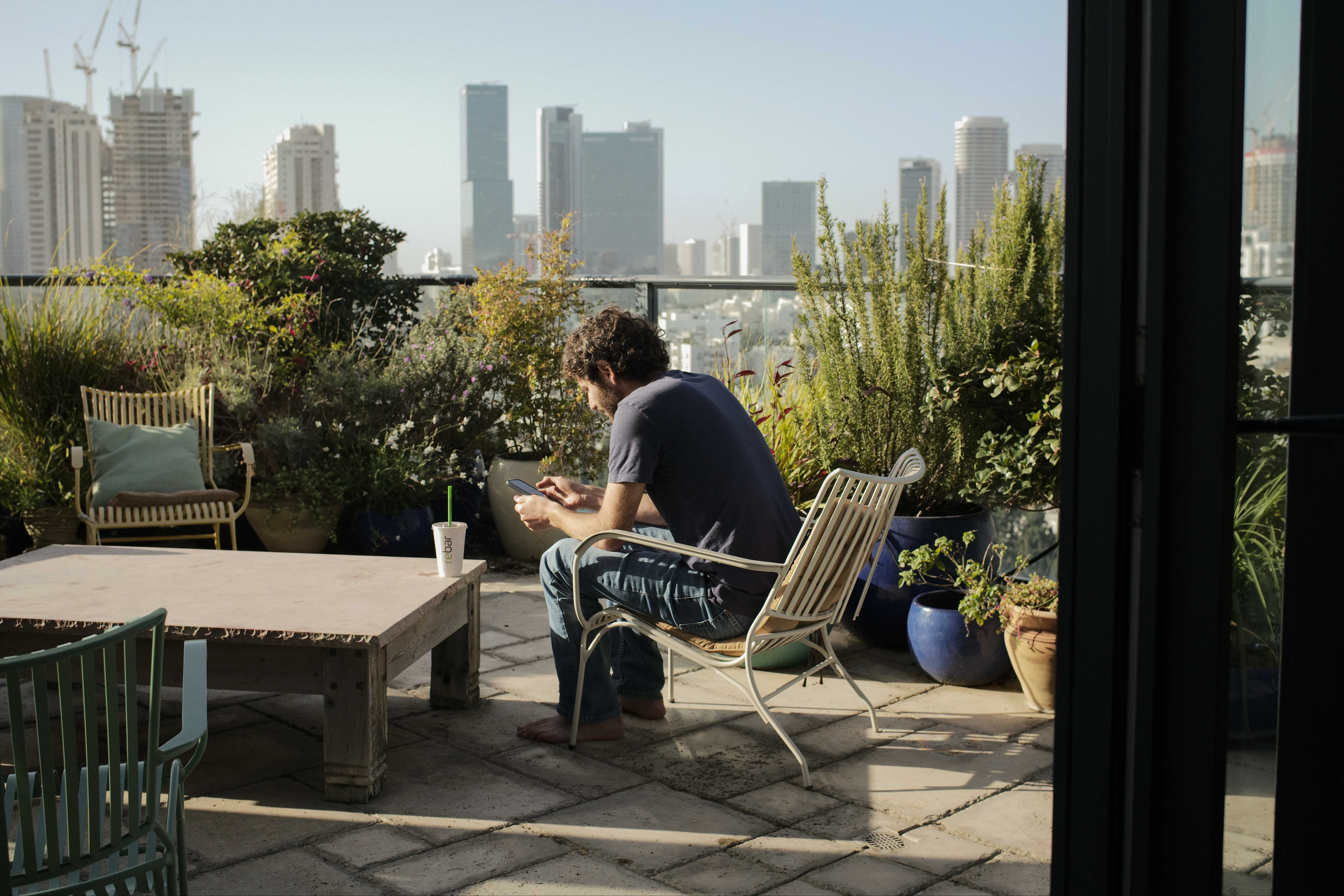 Alon Gat, husband of Yarden Roman-Gat, sits on the balcony of his family’s apartment in Tel Aviv