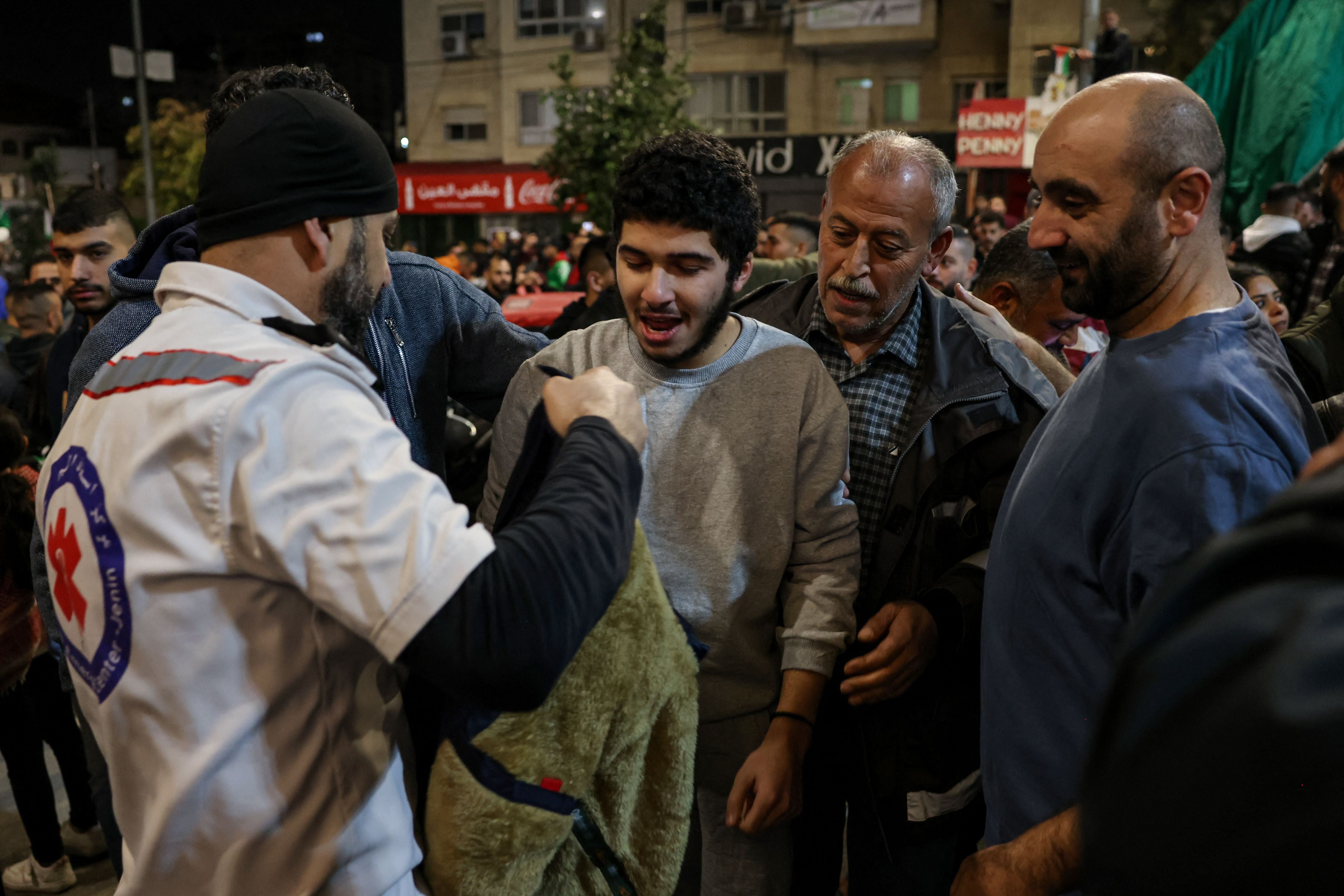 A Palestinian man is welcomed home in the West Bank in the early hours of Sunday