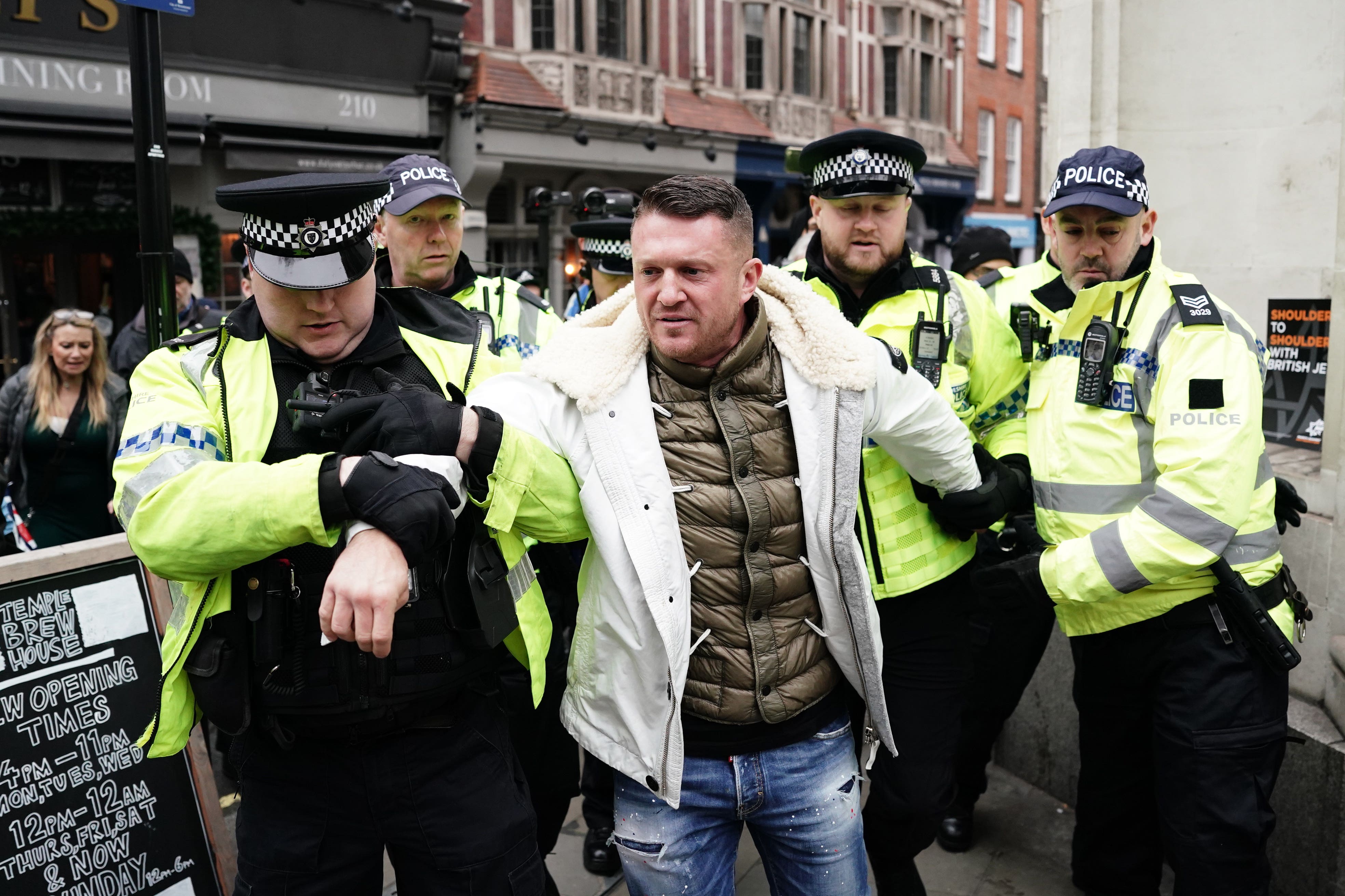 EDL leader Tommy Robinson escorted from antisemitism rally as thousands gather