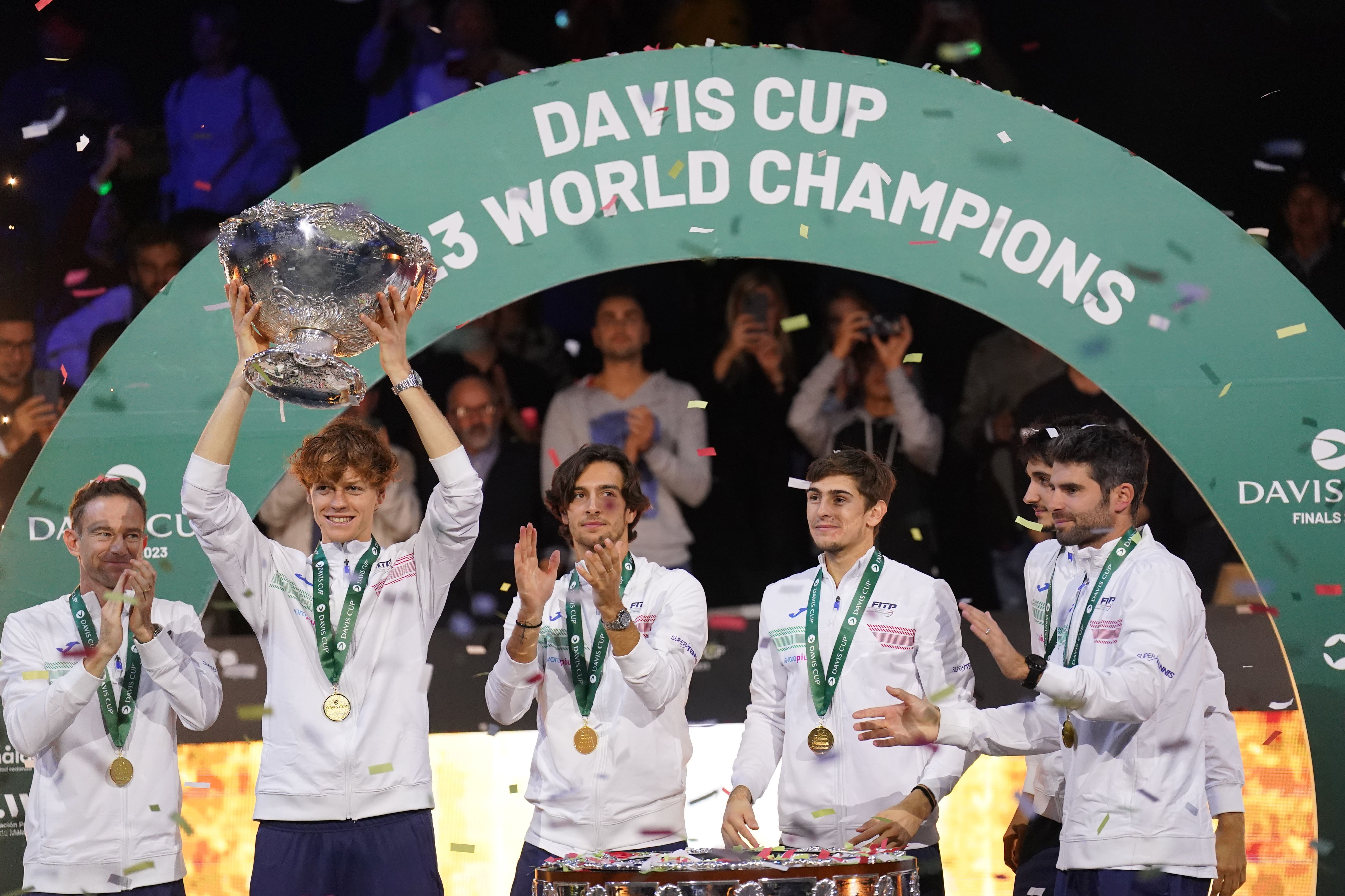 Jannik Sinner lifts the trophy alongside his team-mates (Adam Davy/PA)