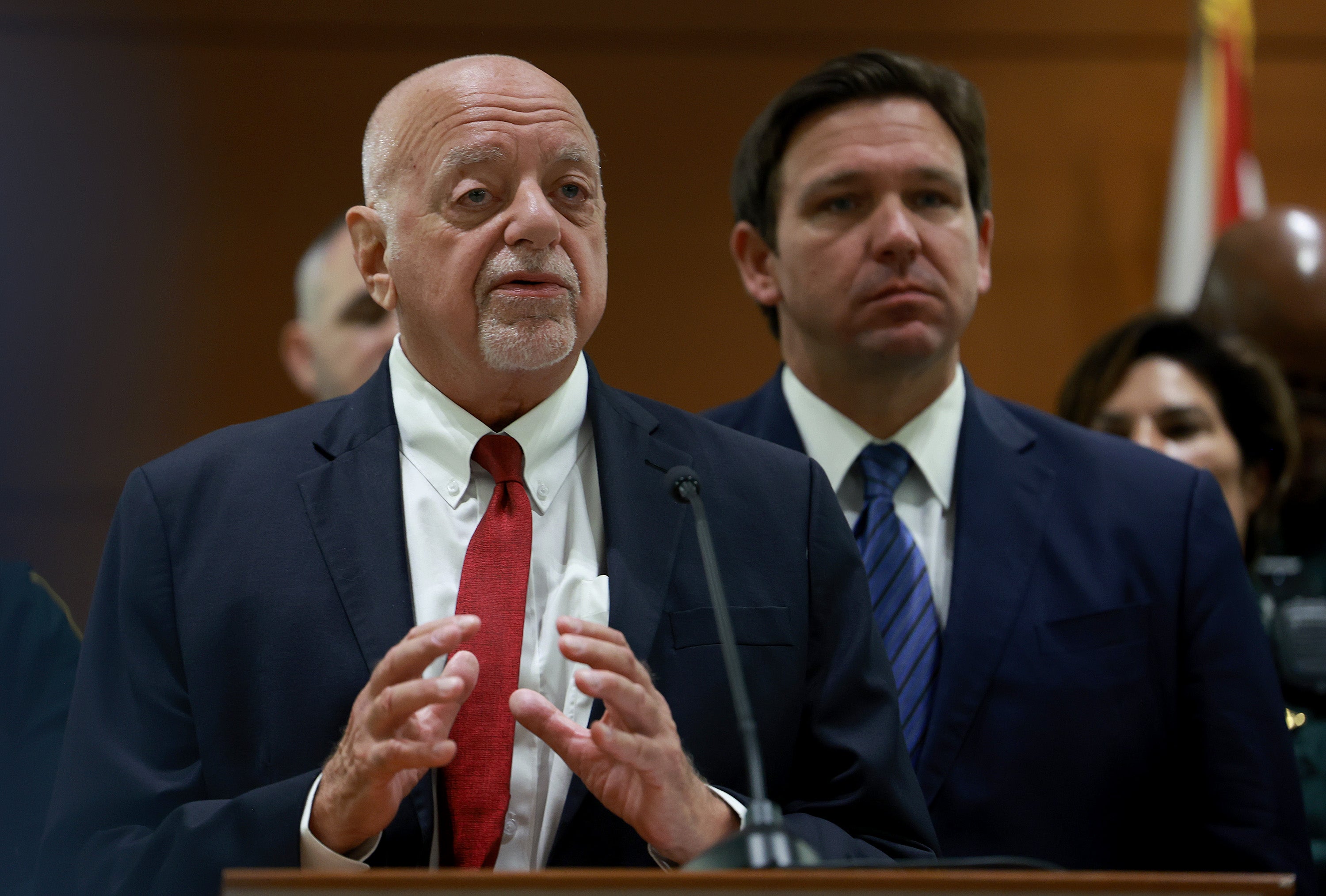 Florida Gov. Ron DeSantis listens as Florida Election Crimes and Security Office Director Peter Antonacci speaks during a press conference at the Broward County Courthouse on August 18, 2022 in Fort Lauderdale, Florida.