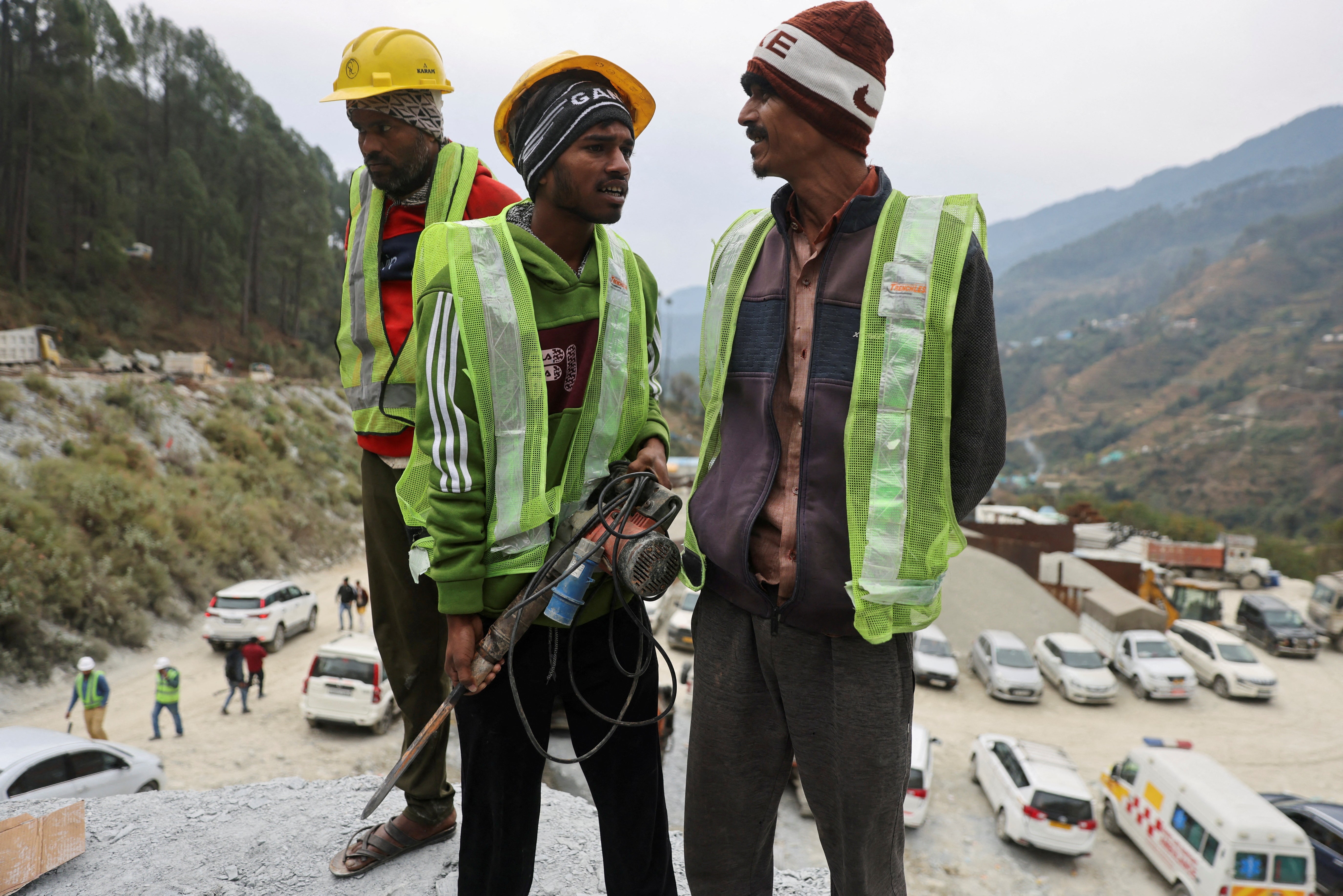 “Rat miners” stand before they begin manual drilling as rescue operations are in progress after workers got trapped in a collapse of an under-construction tunnel