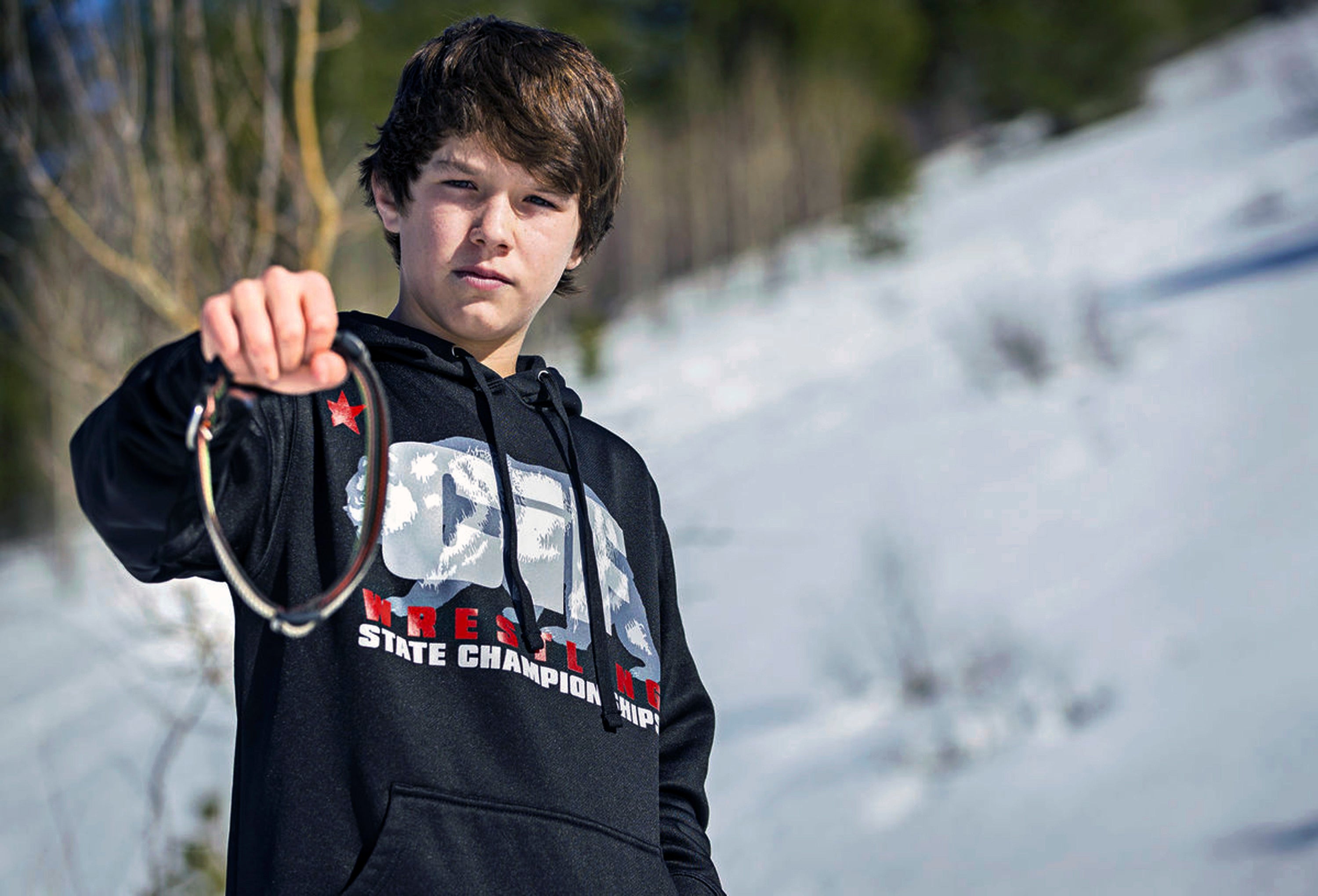 Canyon Mansfield holds the collar of his dog