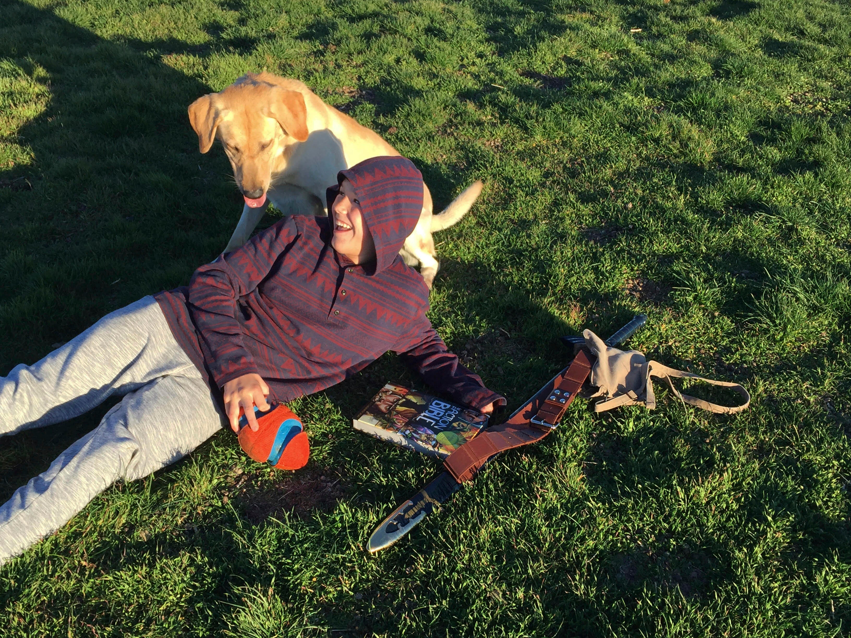 Canyon Mansfield and dog Kasey playing in the grass