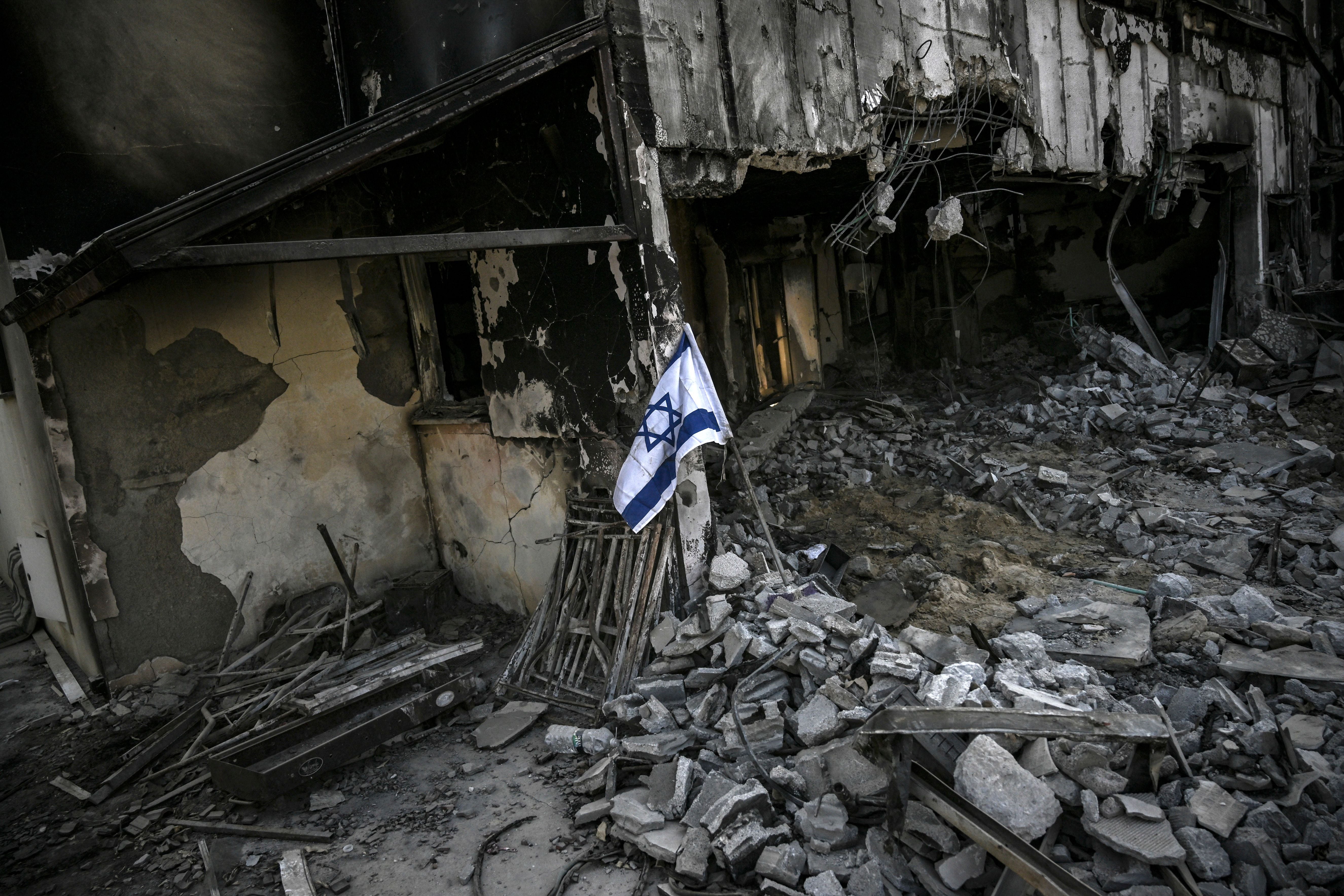 An Israeli flag placed at a destroyed house in Kibbutz Beeri, nearly a month after the 7 October attack by Palestinian militants