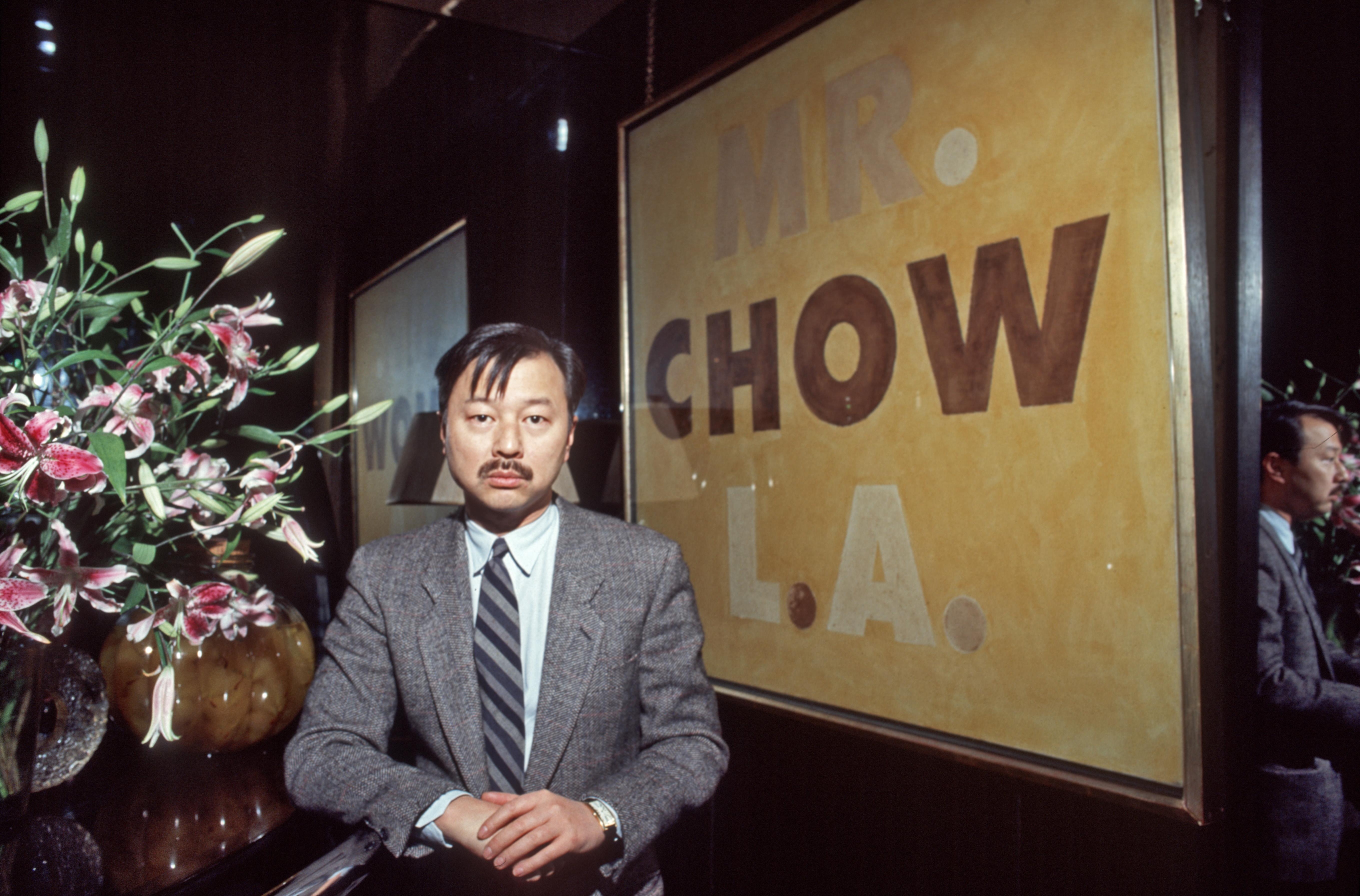 Michael Chow with a 1973 painting by Ed Ruscha at his Los Angeles restaurant