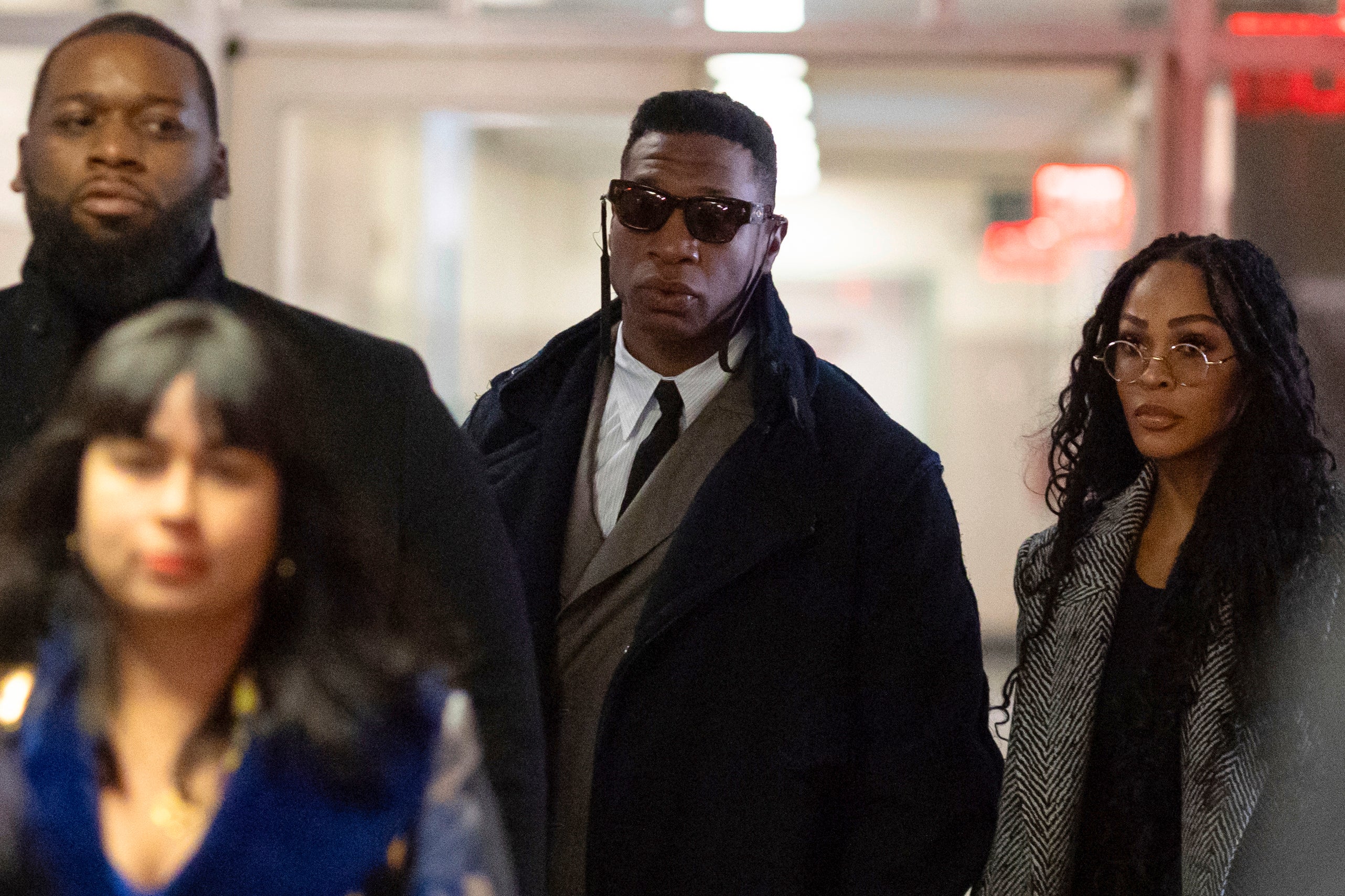 Majors, center, and Meagan Good, right, arrive at court for jury selection in Major's domestic violence case in New York.