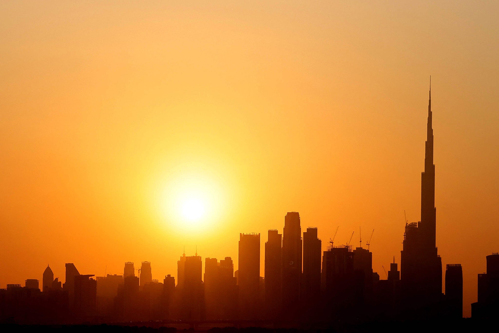 The skyline of downtown Dubai with Burj Khalifa at sunset