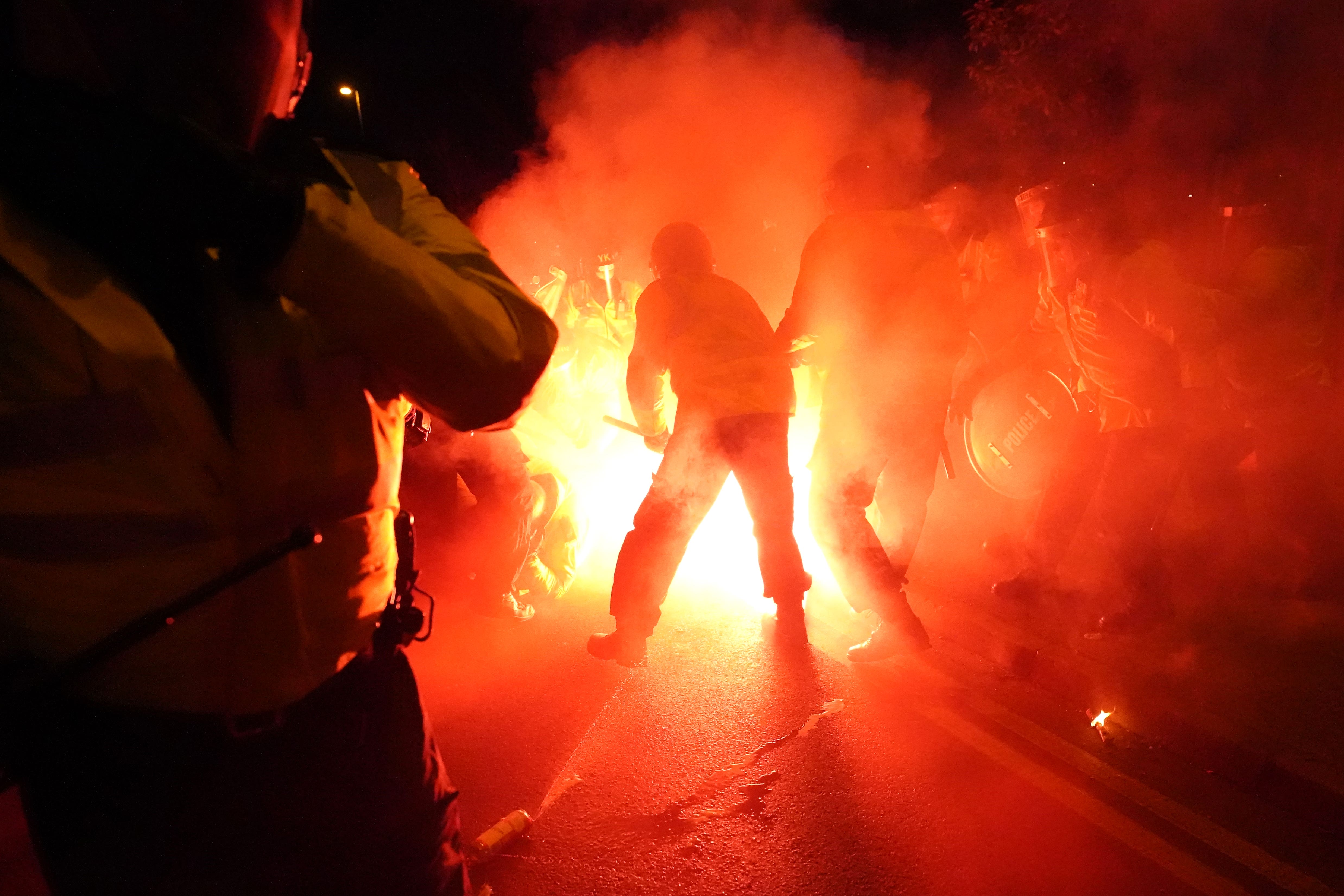 A police officer appears to be hit by a flare outside the stadium ahead of the UEFA Europa Conference League Group E match at Villa Park, Birmingham (David Davies/PA Wire)