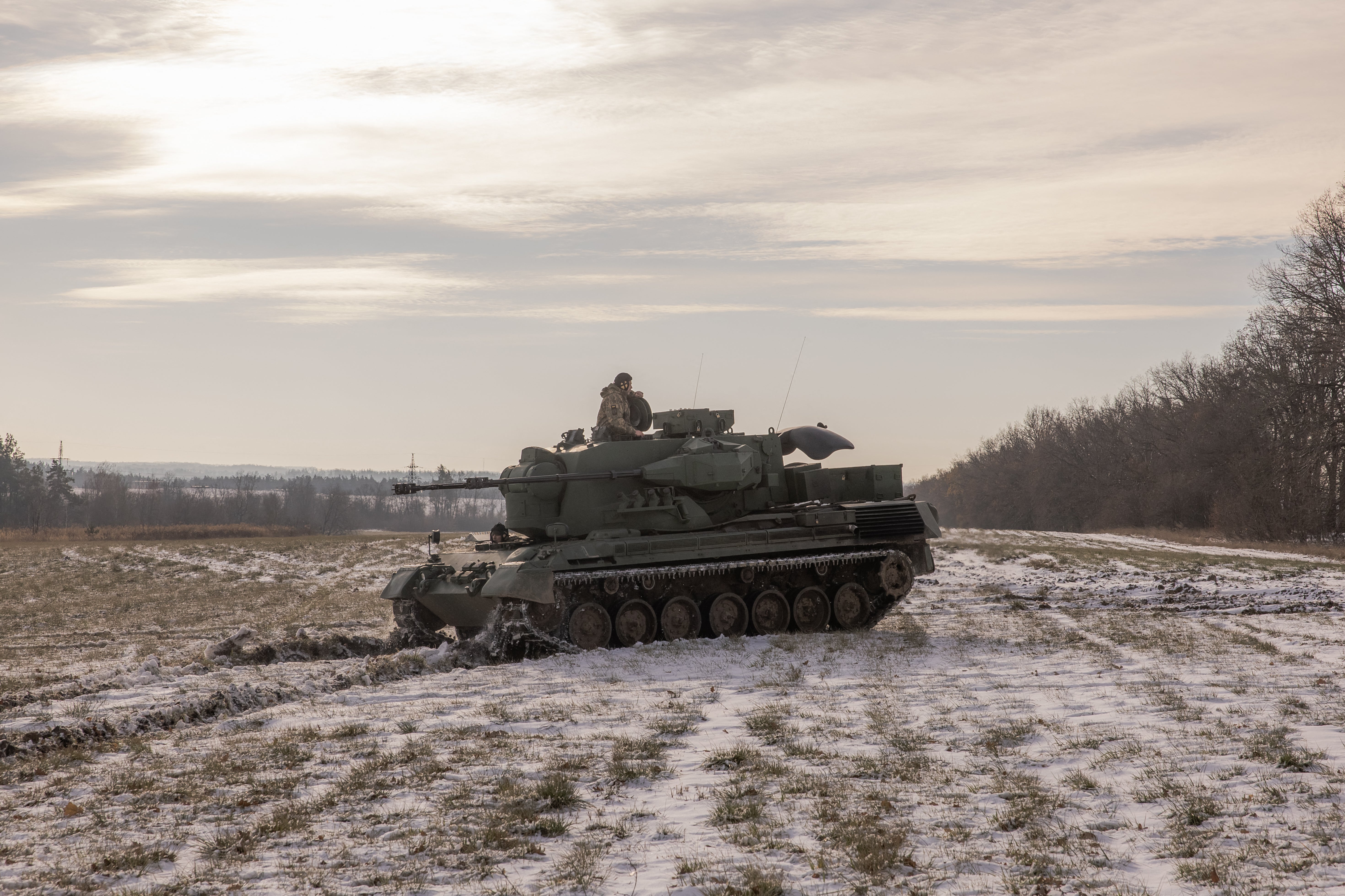 Ukrainian crew members drive a German Gepard anti-aircraft-gun tank that is used to target Russian launched drones in the outskirts of Kyiv