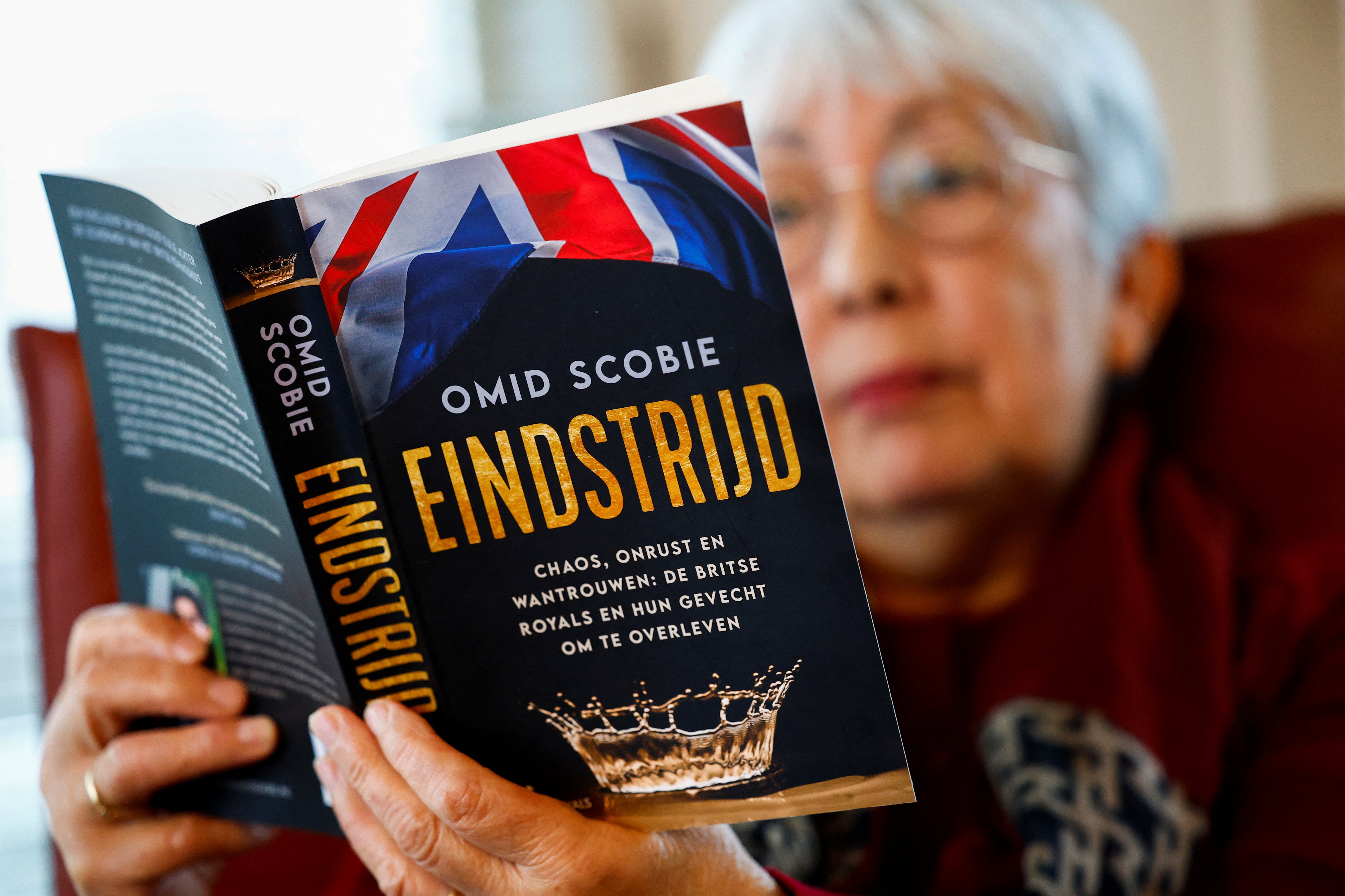 A woman reads a Dutch translation of ‘Endgame’ by Omid Scobie, a book about the British royal family, in Beuningen, Netherlands