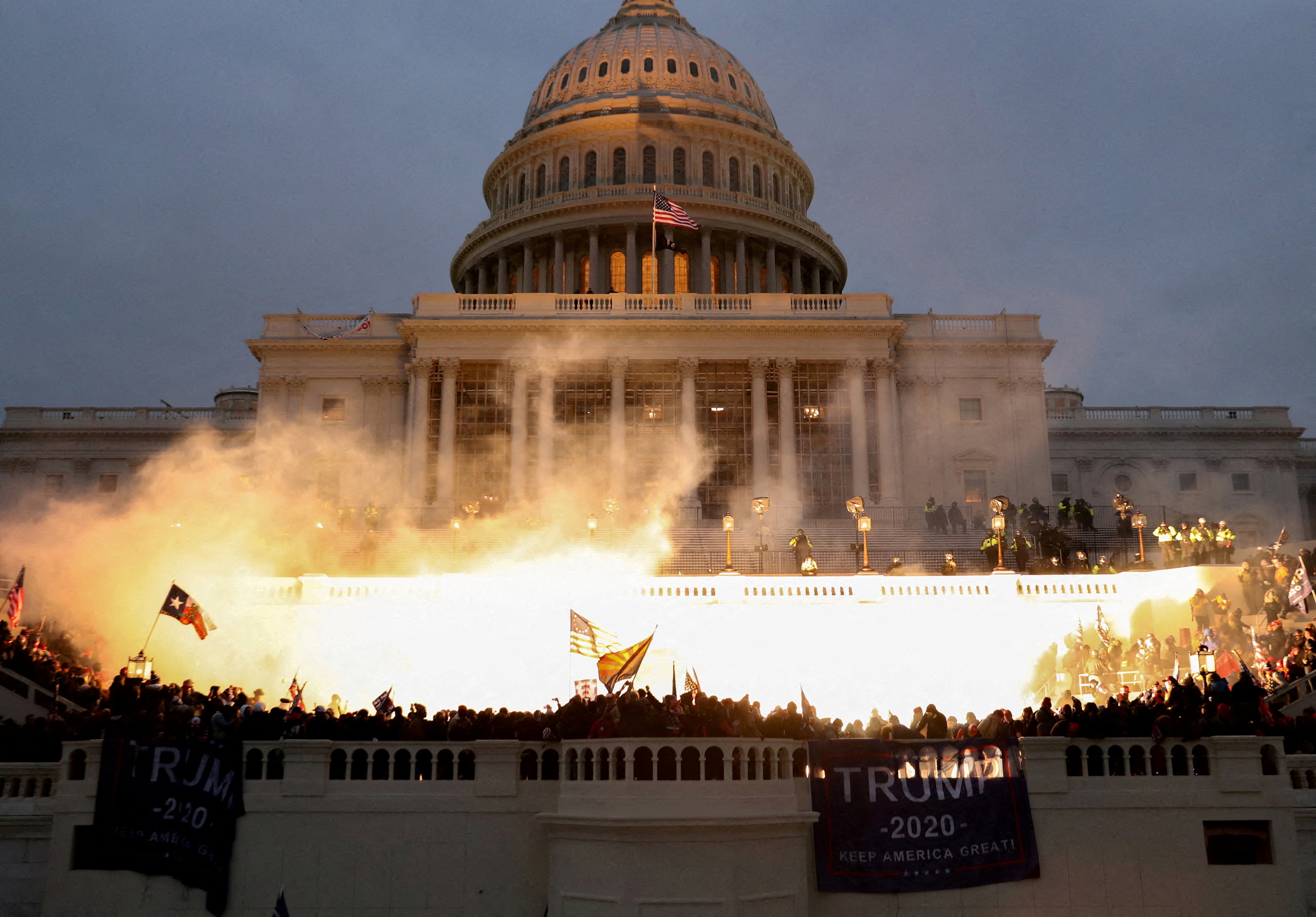 An explosion caused by a police munition is seen while supporters of Donald Trump riot on January 6 2021