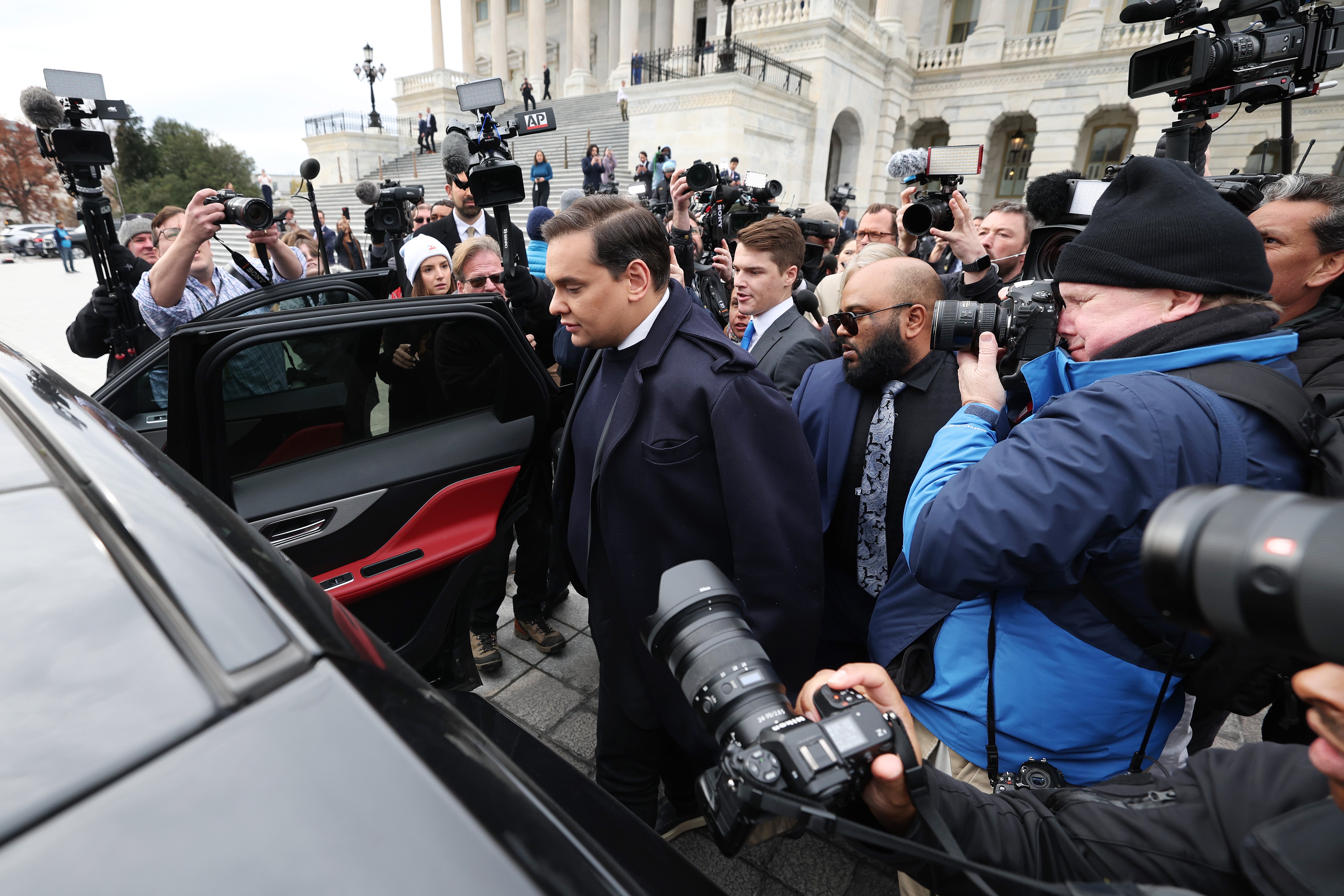 Rep. George Santos (R-NY) is surrounded by journalists as he leaves the US Capitol after his fellow members of Congress voted to expel him from the House of Representatives on December 01, 2023 in Washington, DC