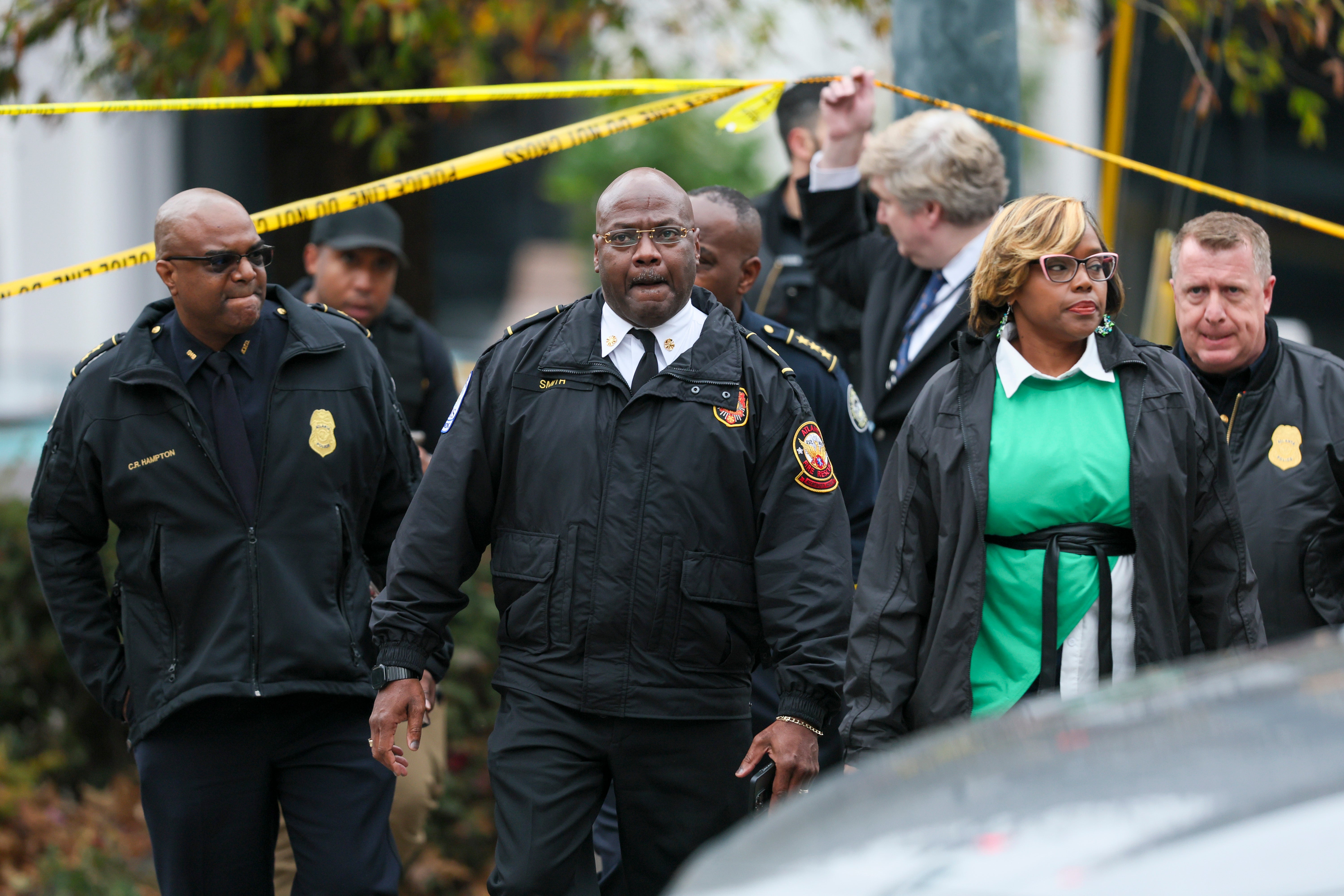 Atlanta Fire Chief Rodrick Smith, center, and others leave the scene after a protester set themself on fire outside the Israeli consulate in Atlanta, Friday, Dec. 1, 2023.