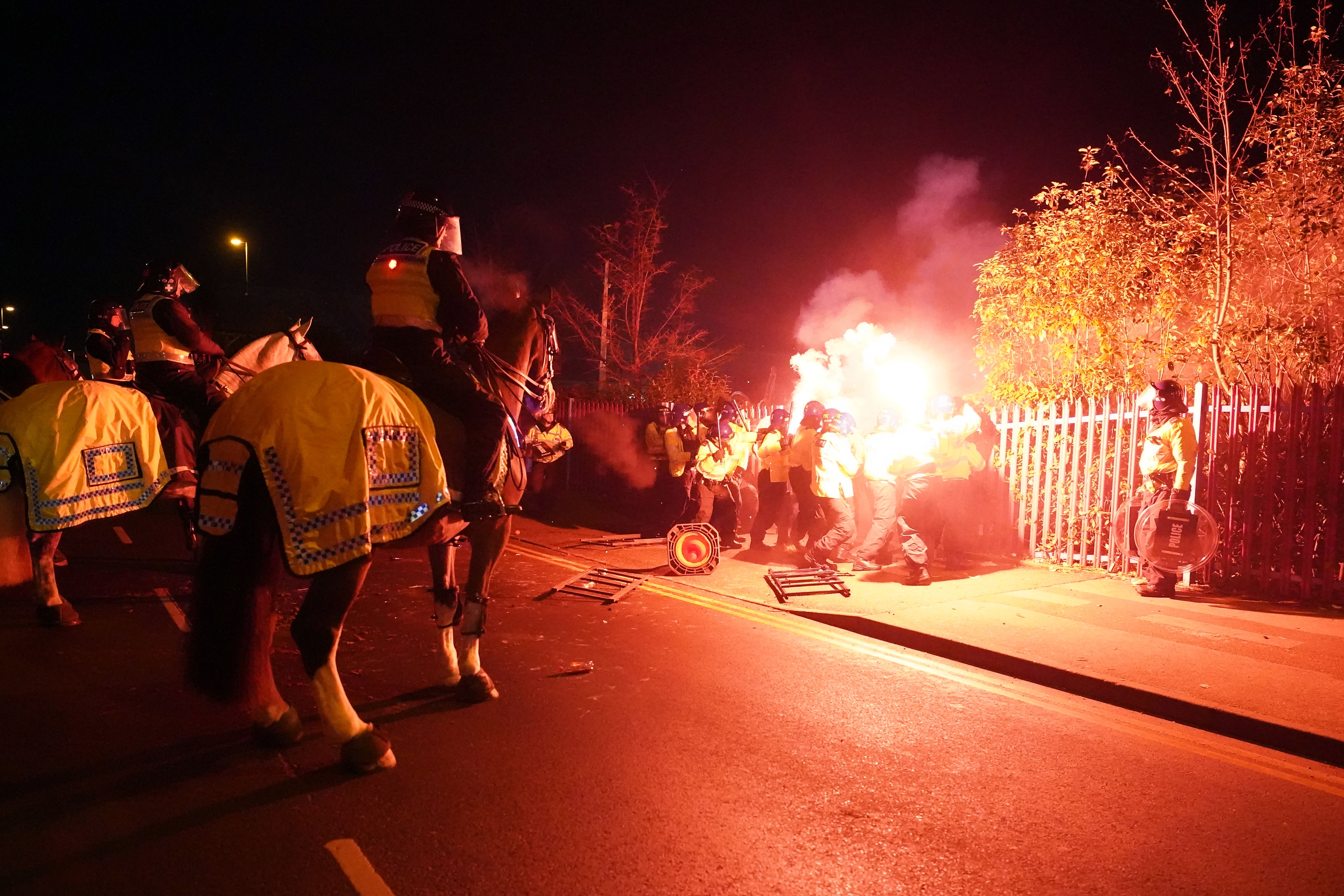 Police attempt to put out flares thrown towards them outside the stadium before the Uefa Europa Conference League Group E match at Villa Park, Birmingham (David Davies/PA)