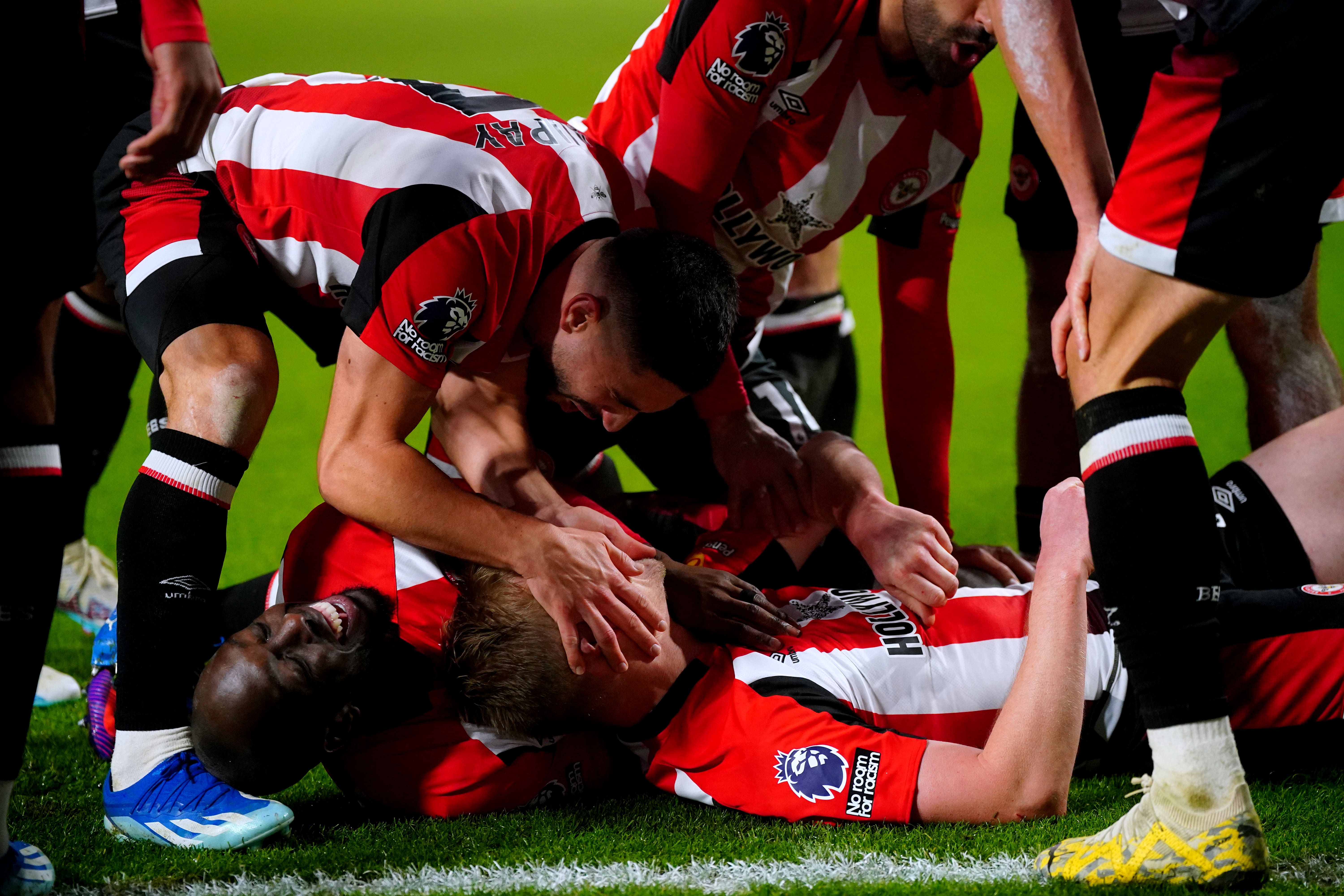 Brentford’s Ben Mee (floor, centre) celebrates with his team-mates after scoring their side’s second goal of the game during the Premier League match at the Gtech Community Stadium, London. Picture date: Saturday December 2, 2023.