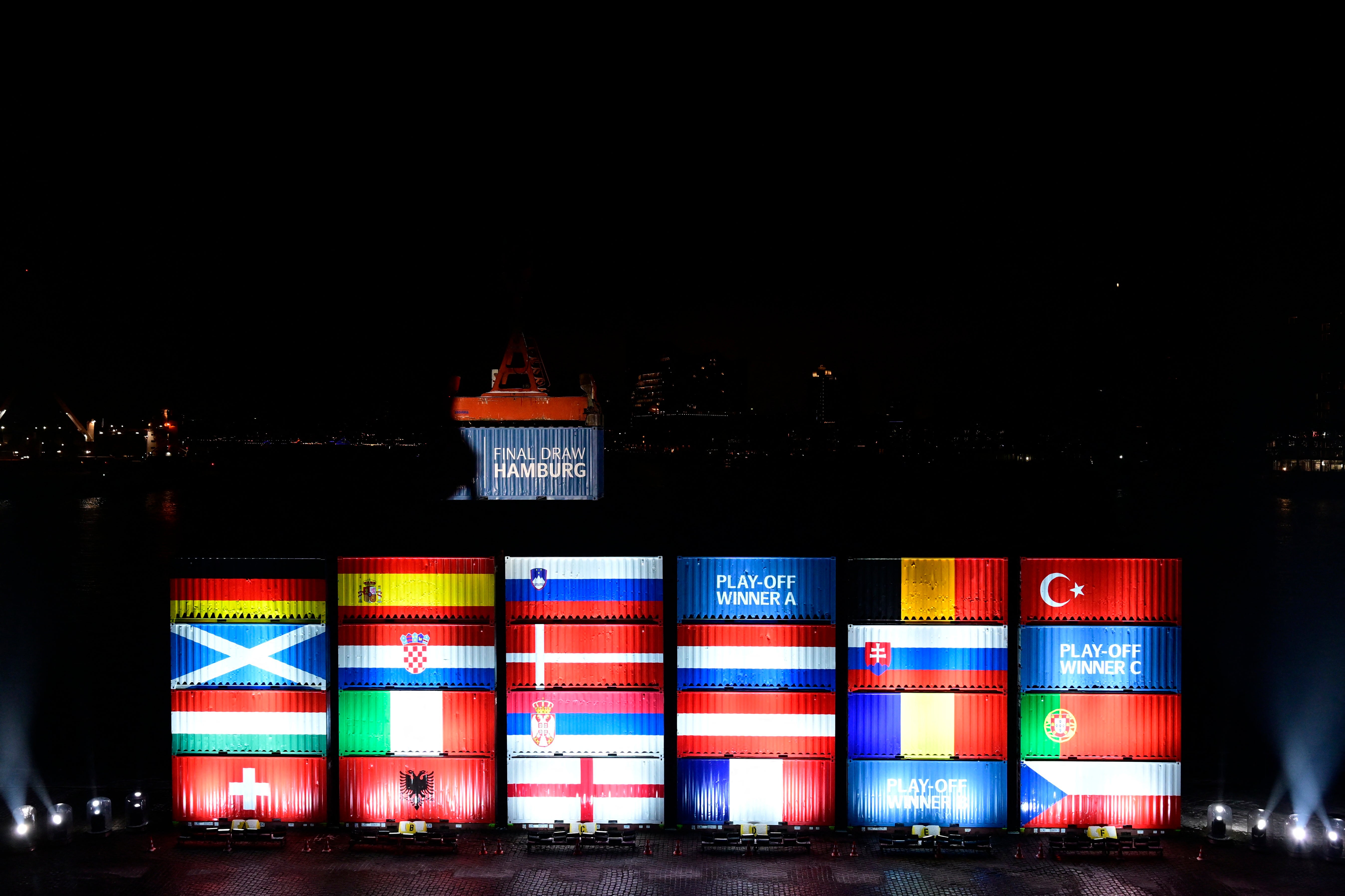 Port workers in Hamburg stack containers with flags of the Euro 2024 teams in accordance with the draw