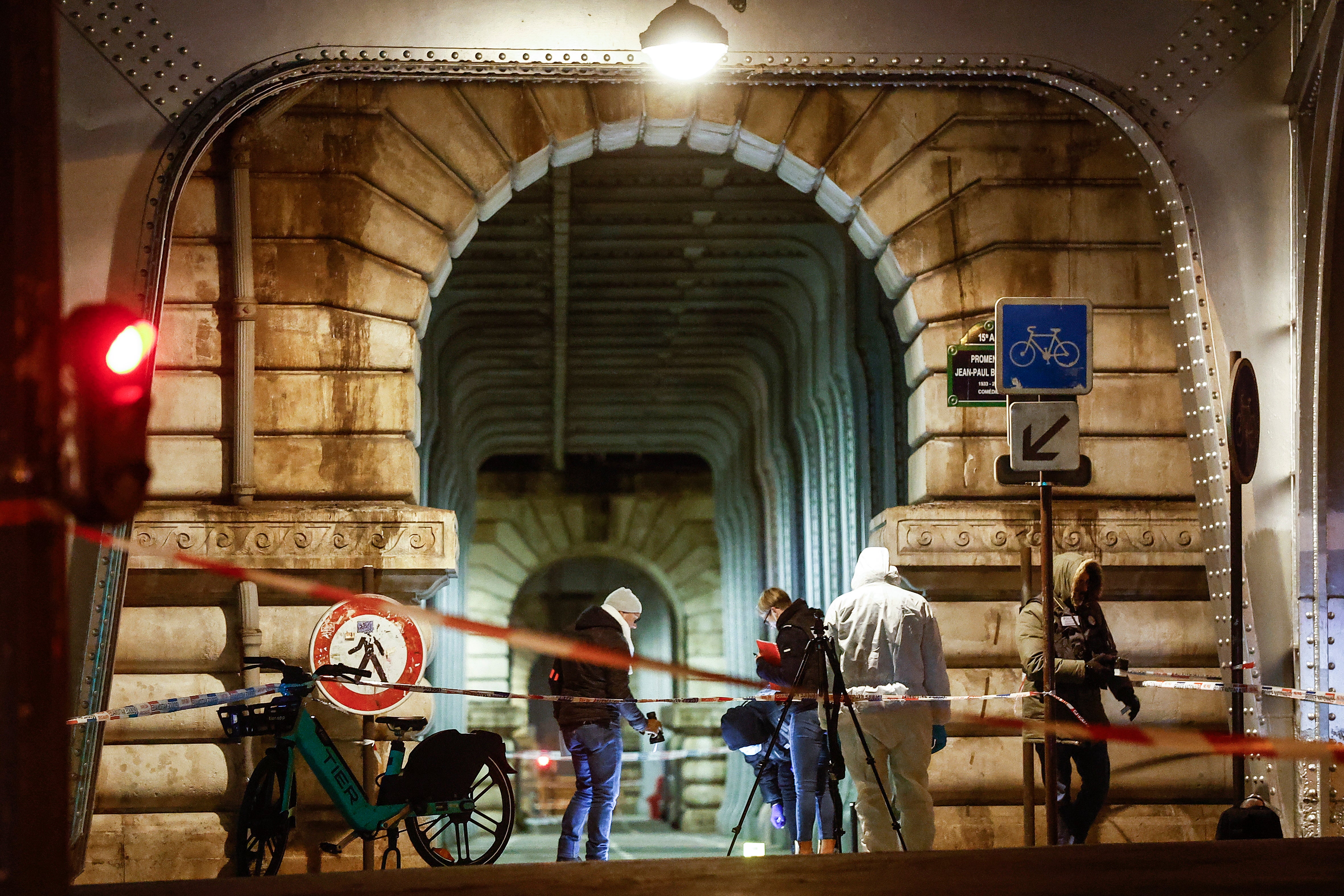 A forensic team investigate the scene following a knife attack in Paris, France