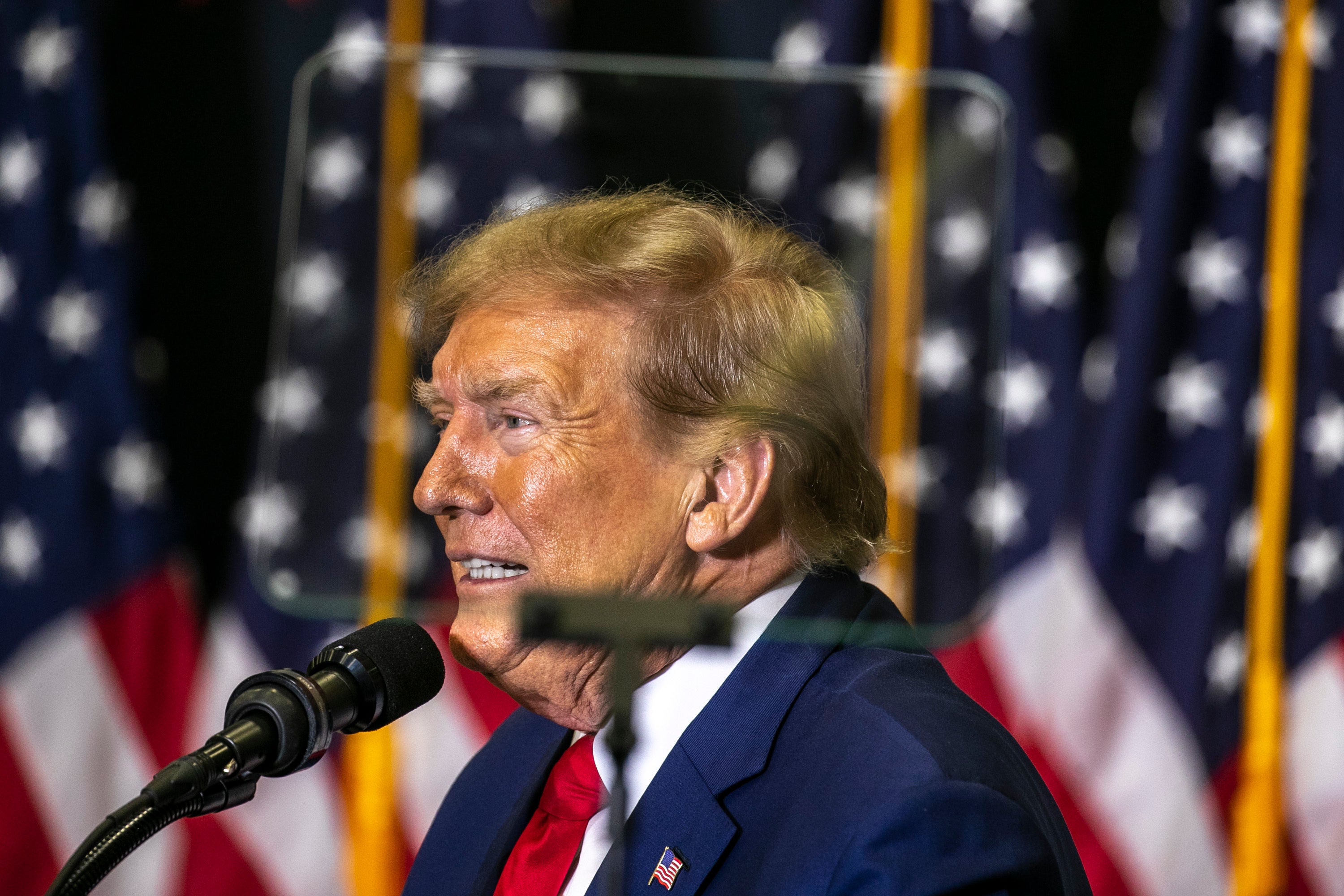 Republican presidential candidate and former President Donald Trump speaks to the crowd during a caucus event in Iowa