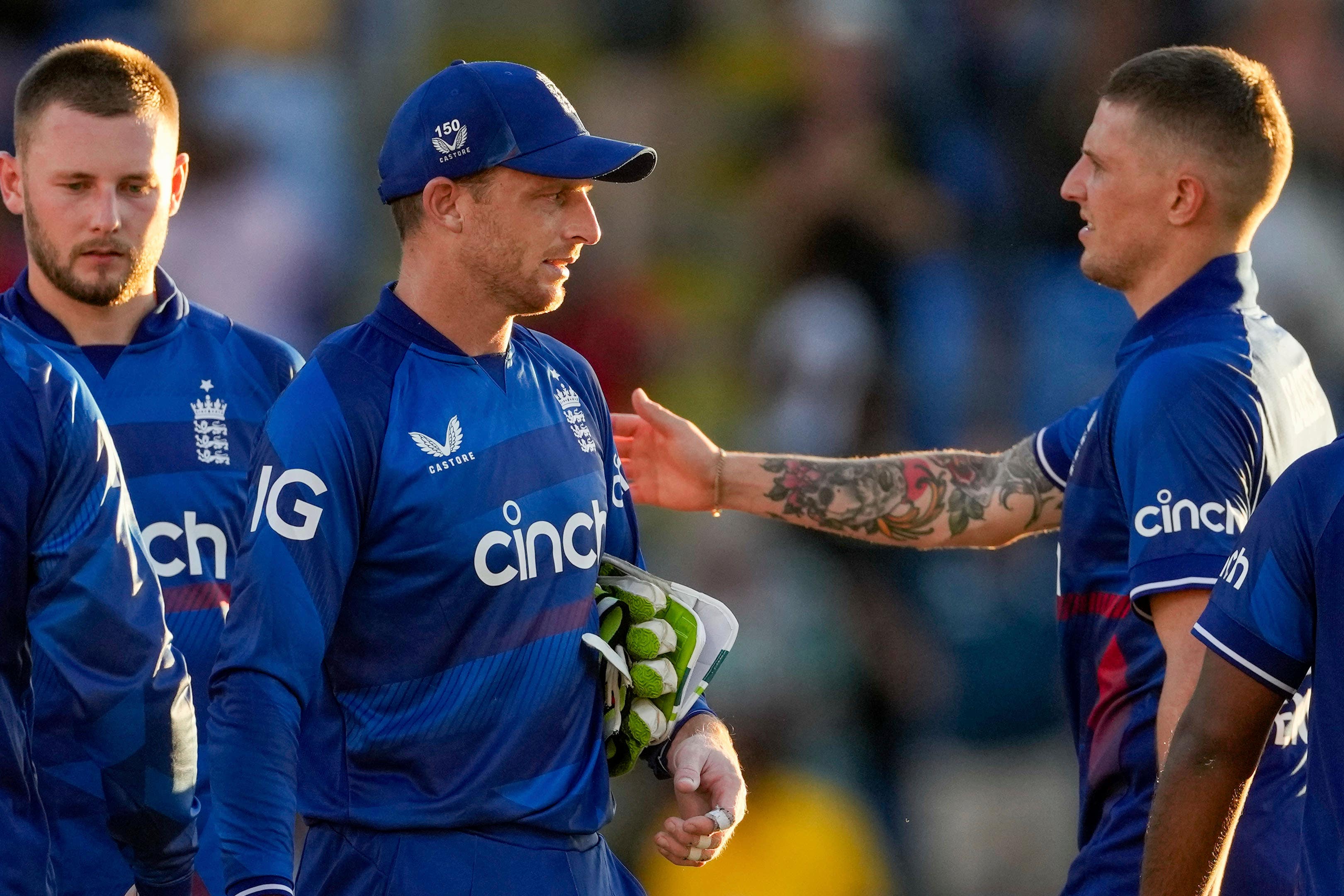 England captain Jos Buttler and team-mates walk off the field after losing the opening ODI (Ricardo Mazalan/AP)