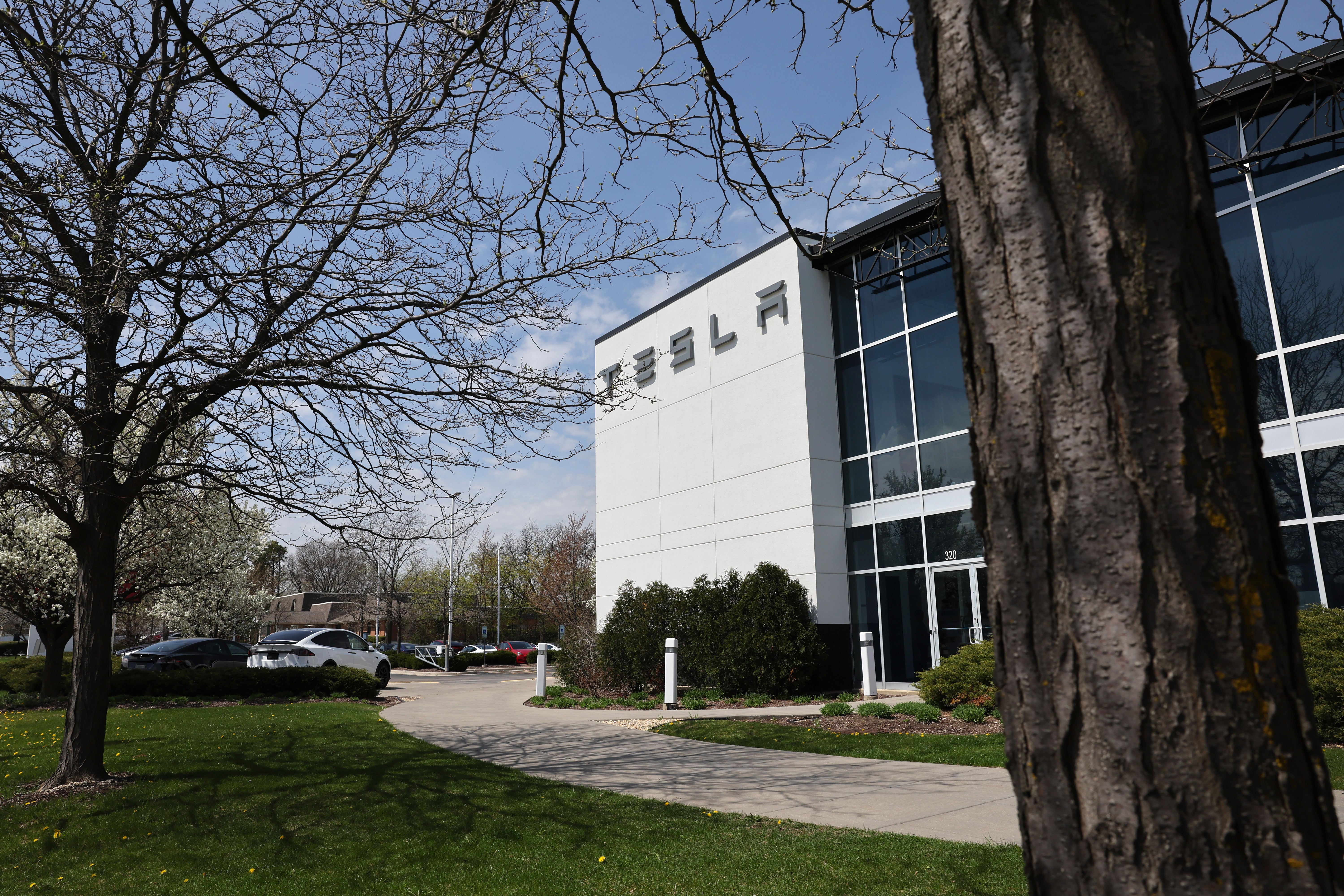 Representative: A sign marks the location of a Tesla dealership