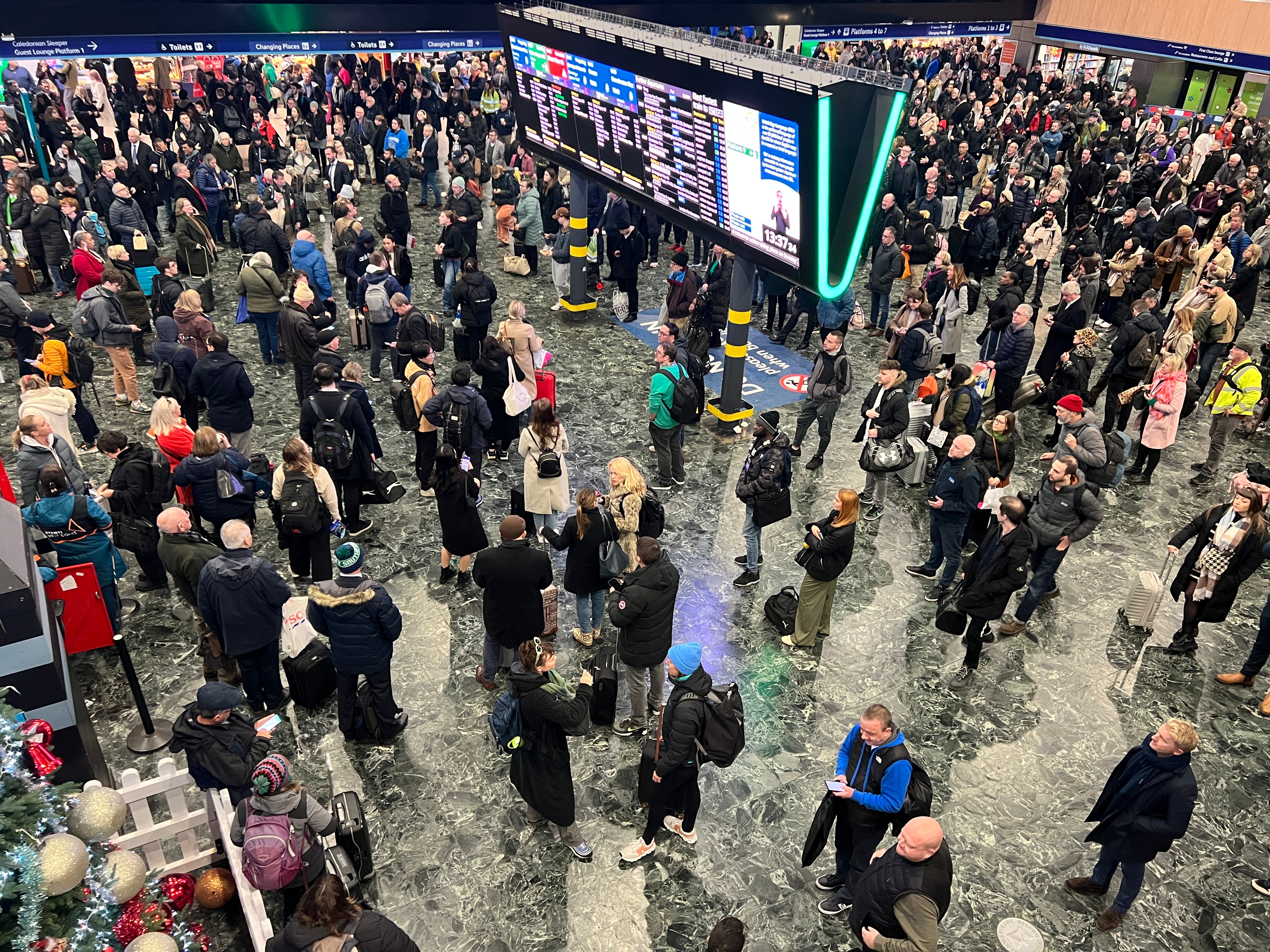 Going places? Crowds build up quickly at London Euston around the newly erected departure screens