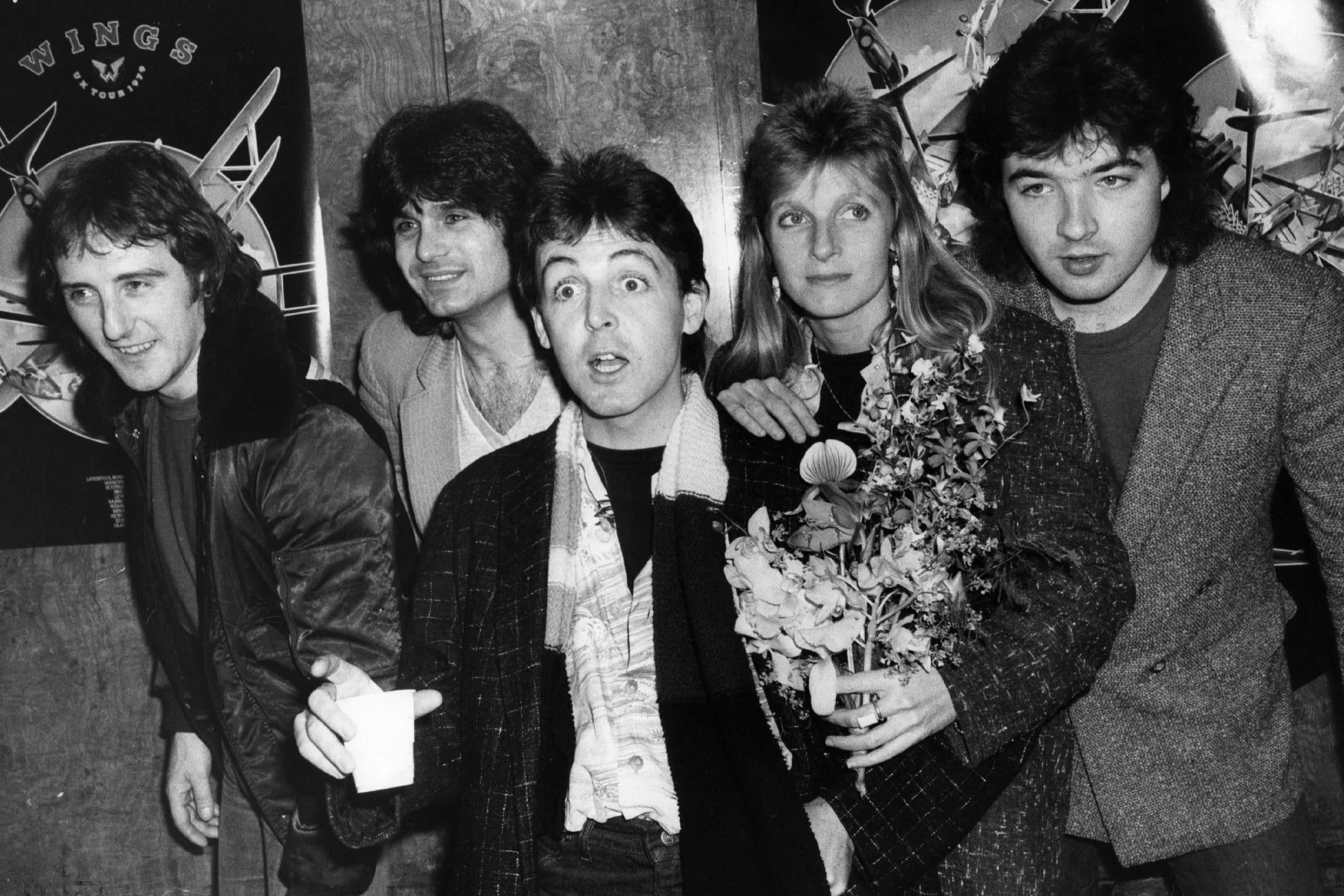 Wings (left-right): Denny Laine, Steve Holly, Paul McCartney, Linda McCartney, and Laurence Juber.