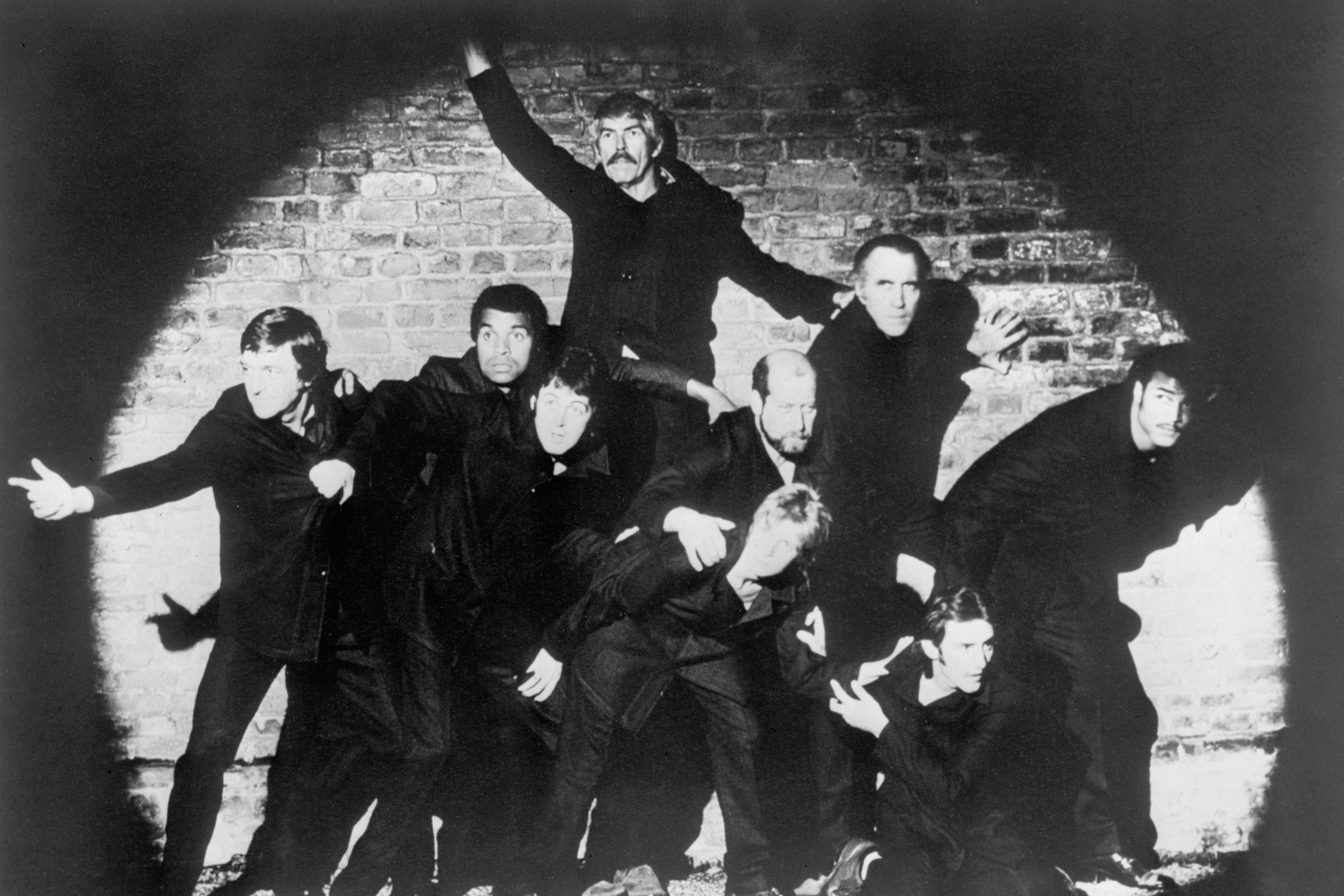 From left, BBC personality Michael Parkinson, singer Kenny Lynch, actor James Coburn (behind), Paul McCartney (below), MP Clement Freud, Linda McCartney, actor Christopher Lee, singer-songwriter Denny Laine (below) and boxer John Conteh. (Clive Arrowsmith/PA)