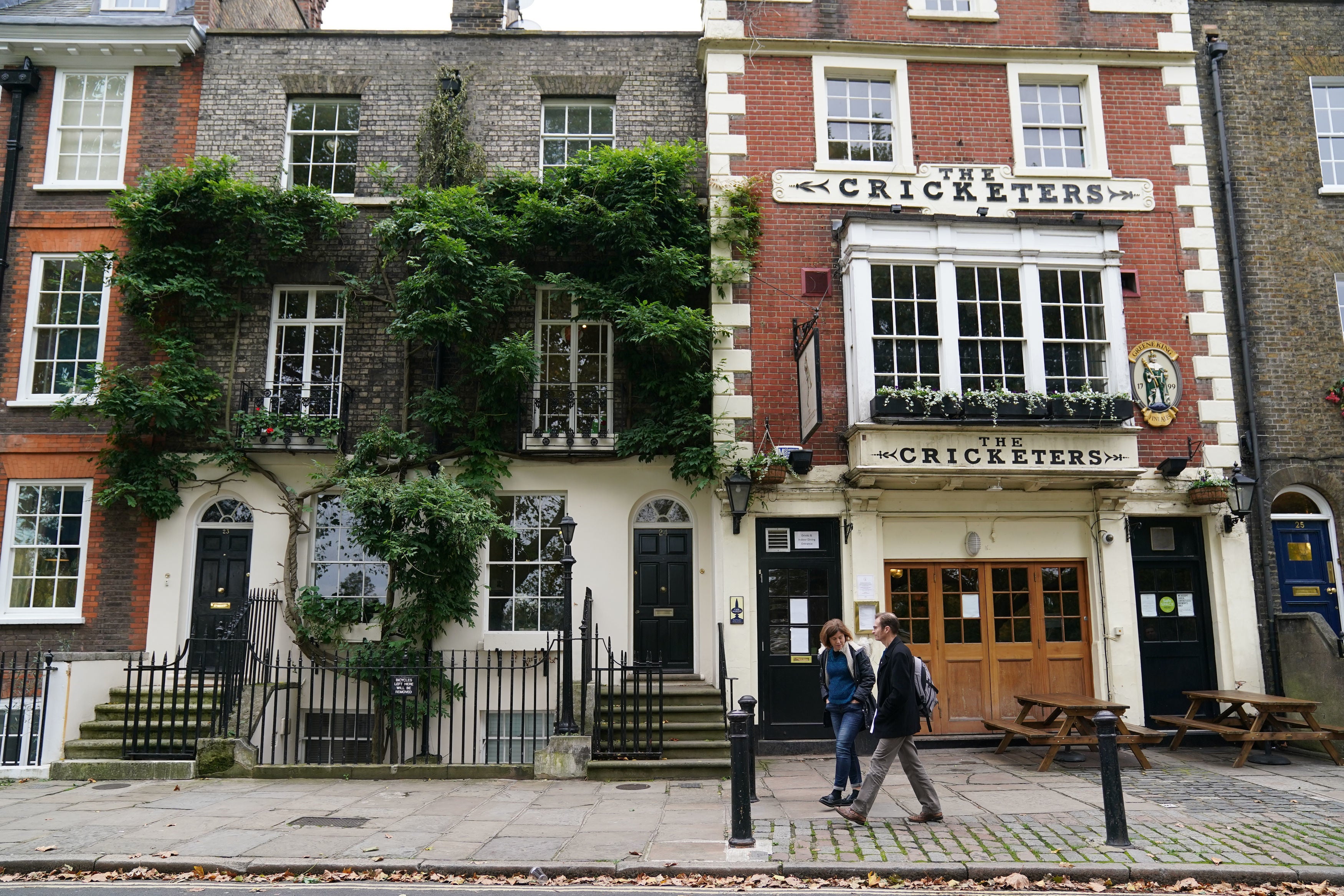 People walk past a public house in Richmond upon Thames