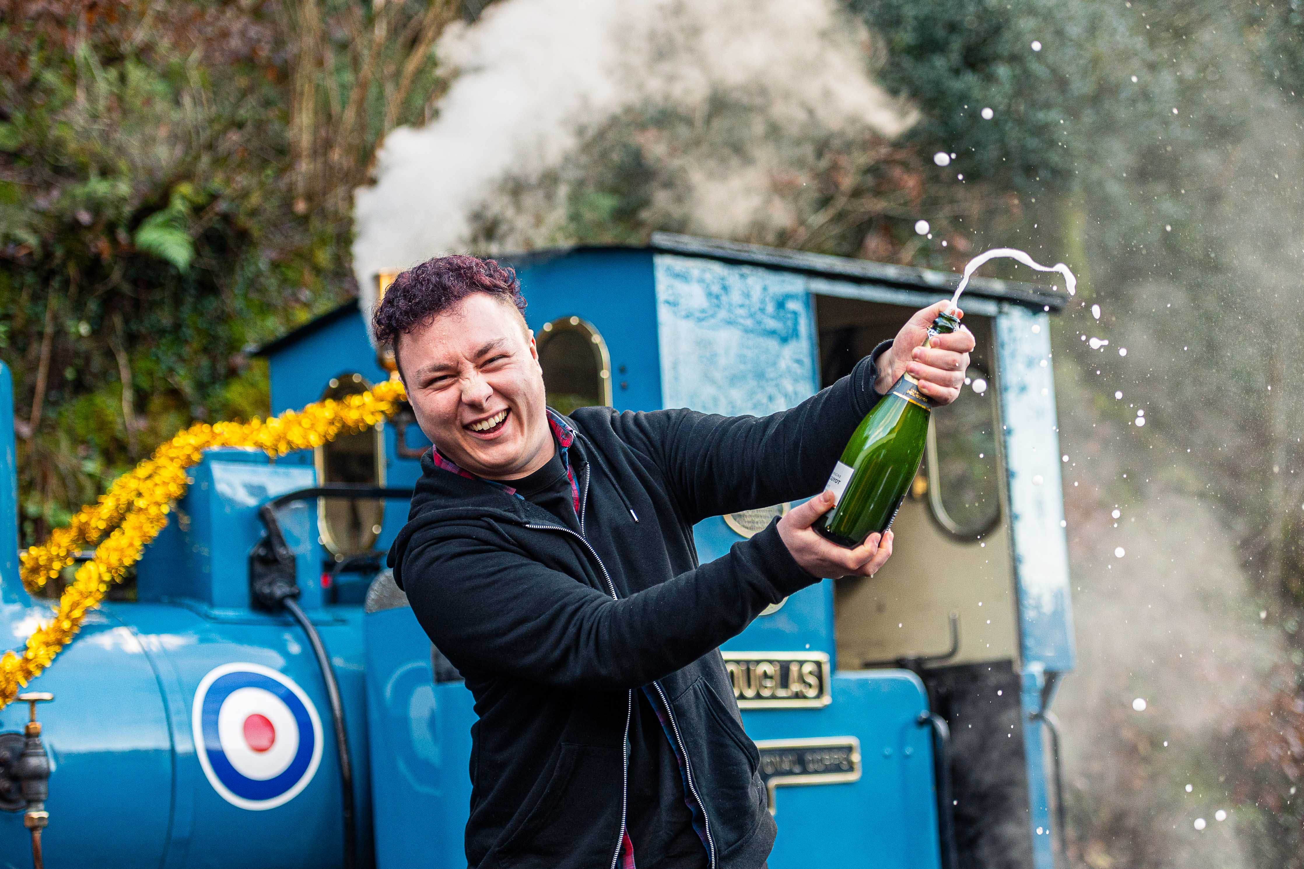 Neil Leighton celebrates his £1 million National Lottery win at the Talyllyn Railway, Gwynedd (National Lottery/PA)