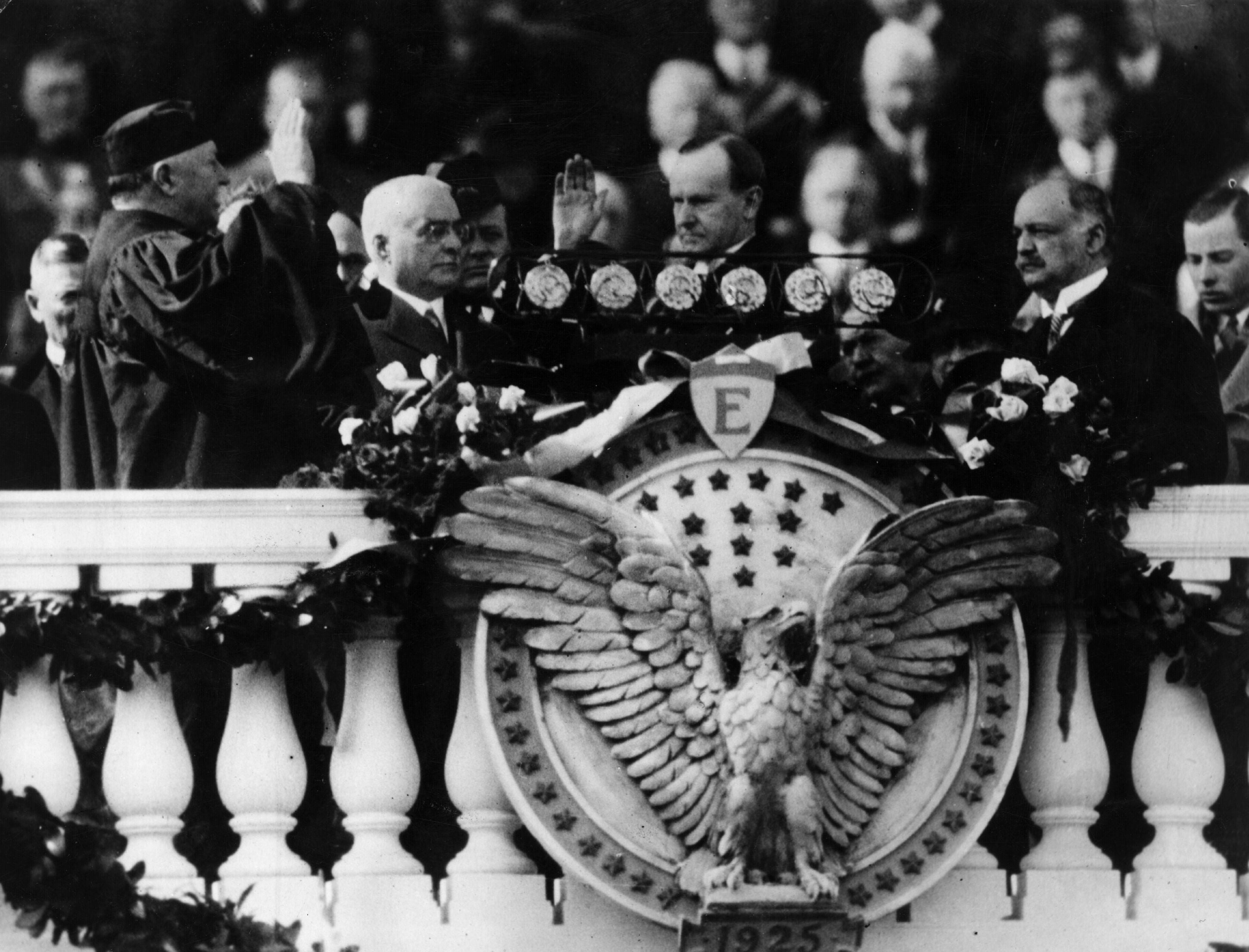 The inauguration of Calvin Coolidge (1872 - 1933) as the 30th President of the United States of America. Chief Justice of the Supreme Court and former President, William Howard Taft (left) administers the oath