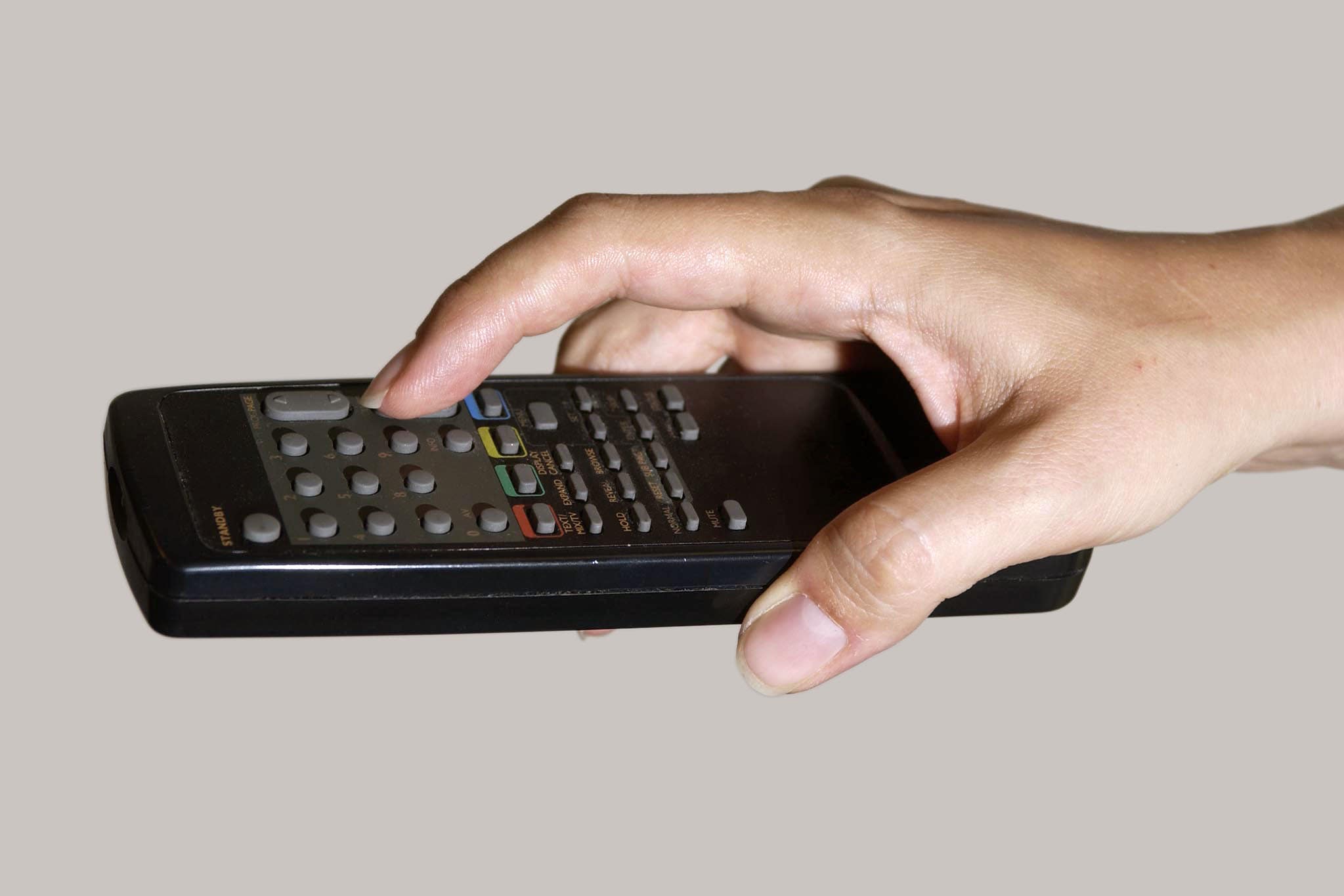 A hand holding a television remote control (Myung Jung Kim/PA)