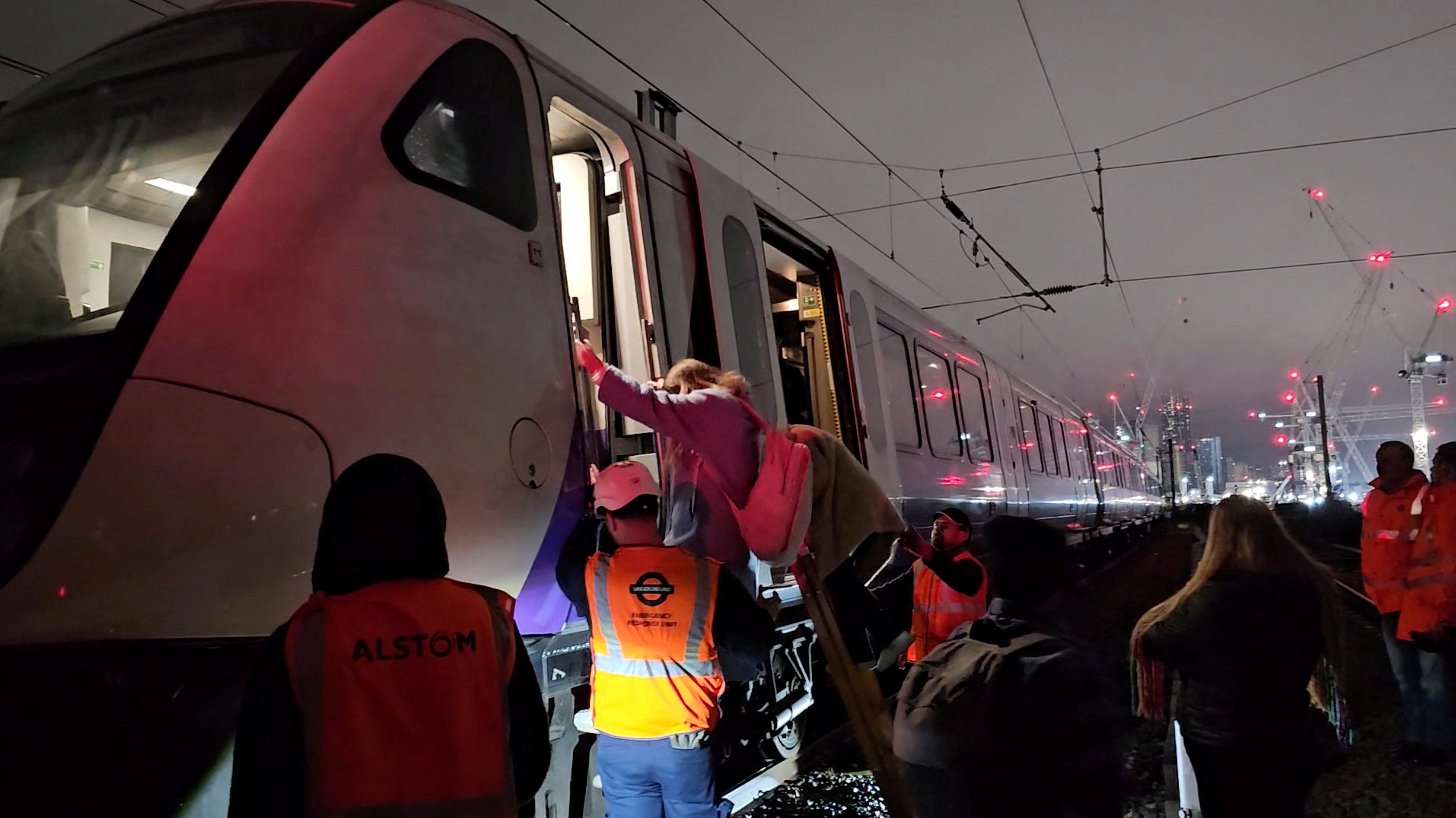 Commuters evacuated the train and carried luggage along the railway tracks