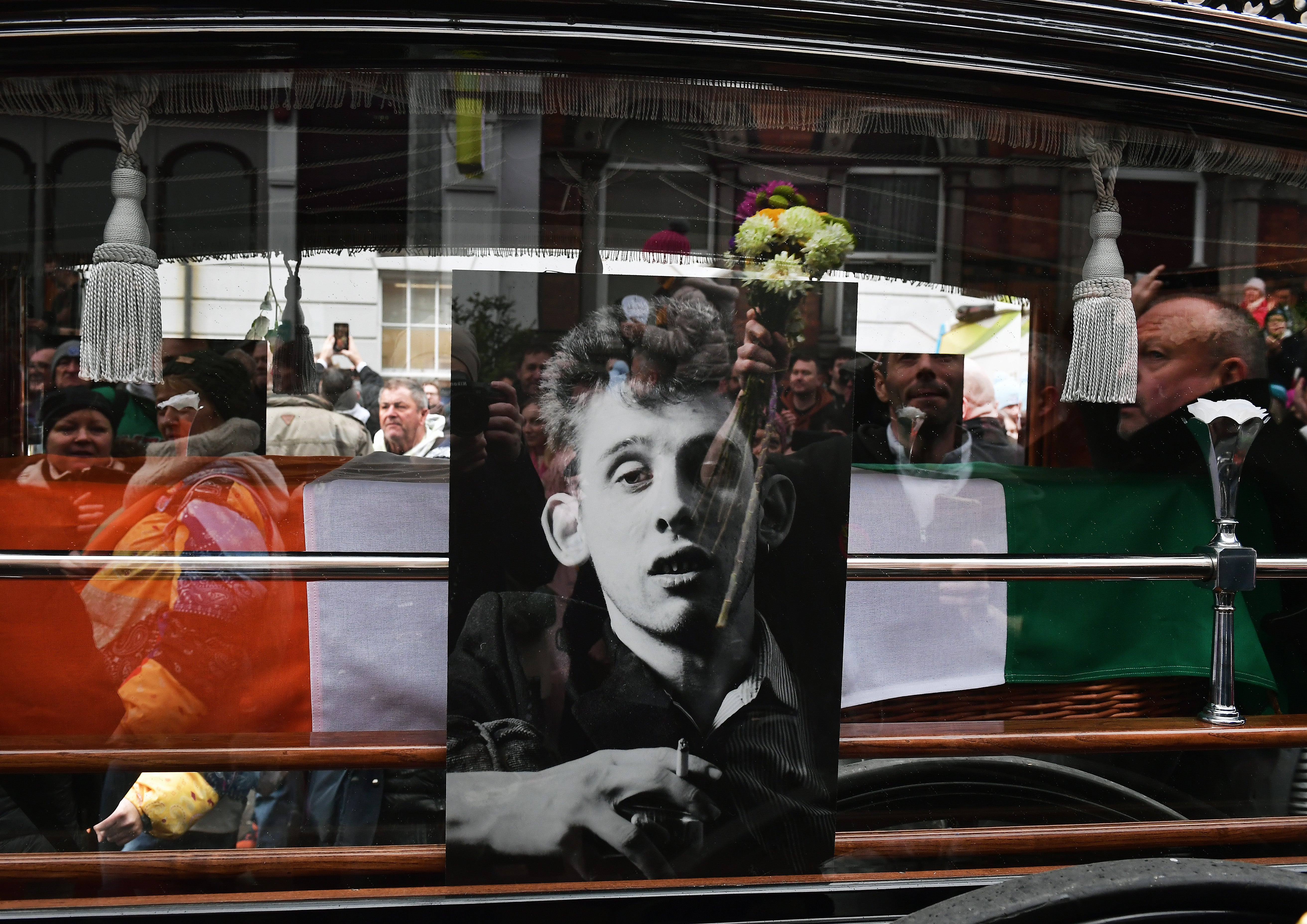 Crowds gather to pay their respects at the funeral procession in Ireland