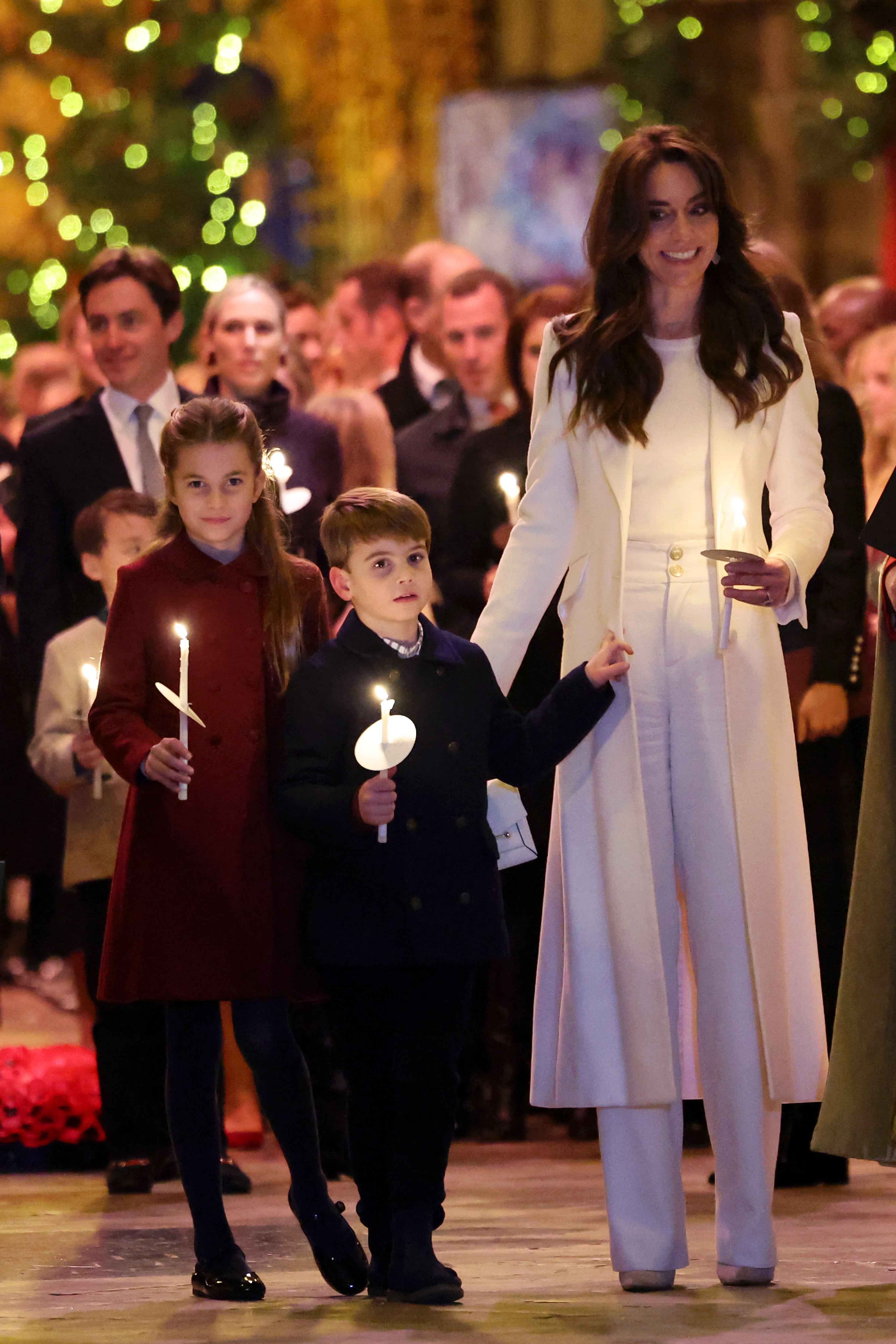 Prince Louis and Princess Charlotte dutifully hold candles at their mother’s event