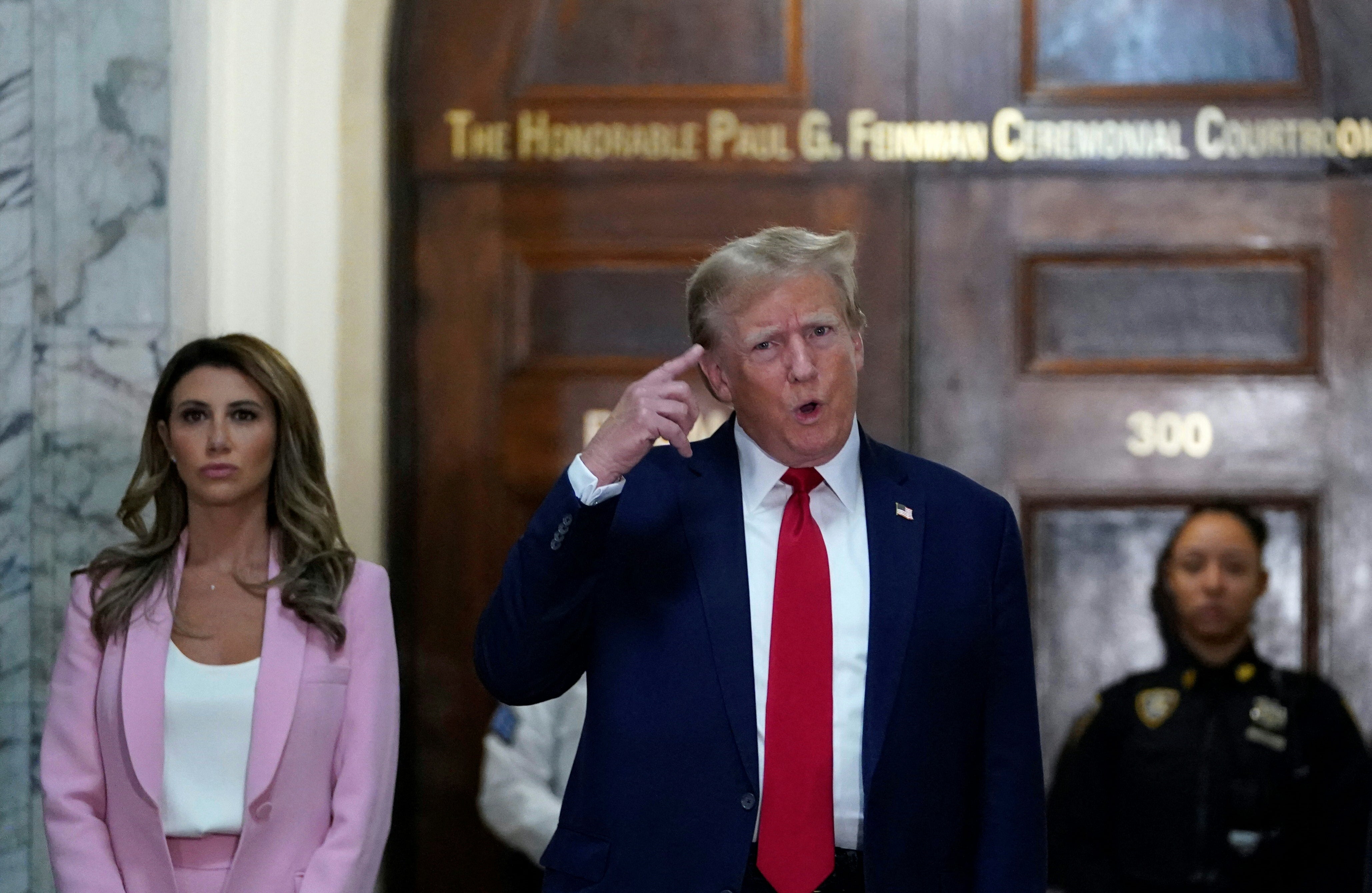 Donald Trump and his attorney Alina Habba, left, appear outside Judge Arthur Engoron’s courtroom on 7 December.