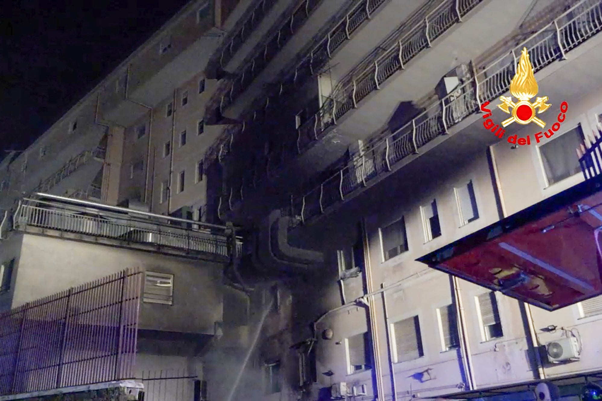 Firefighters spray water at the Italian hospital after a fire broke out