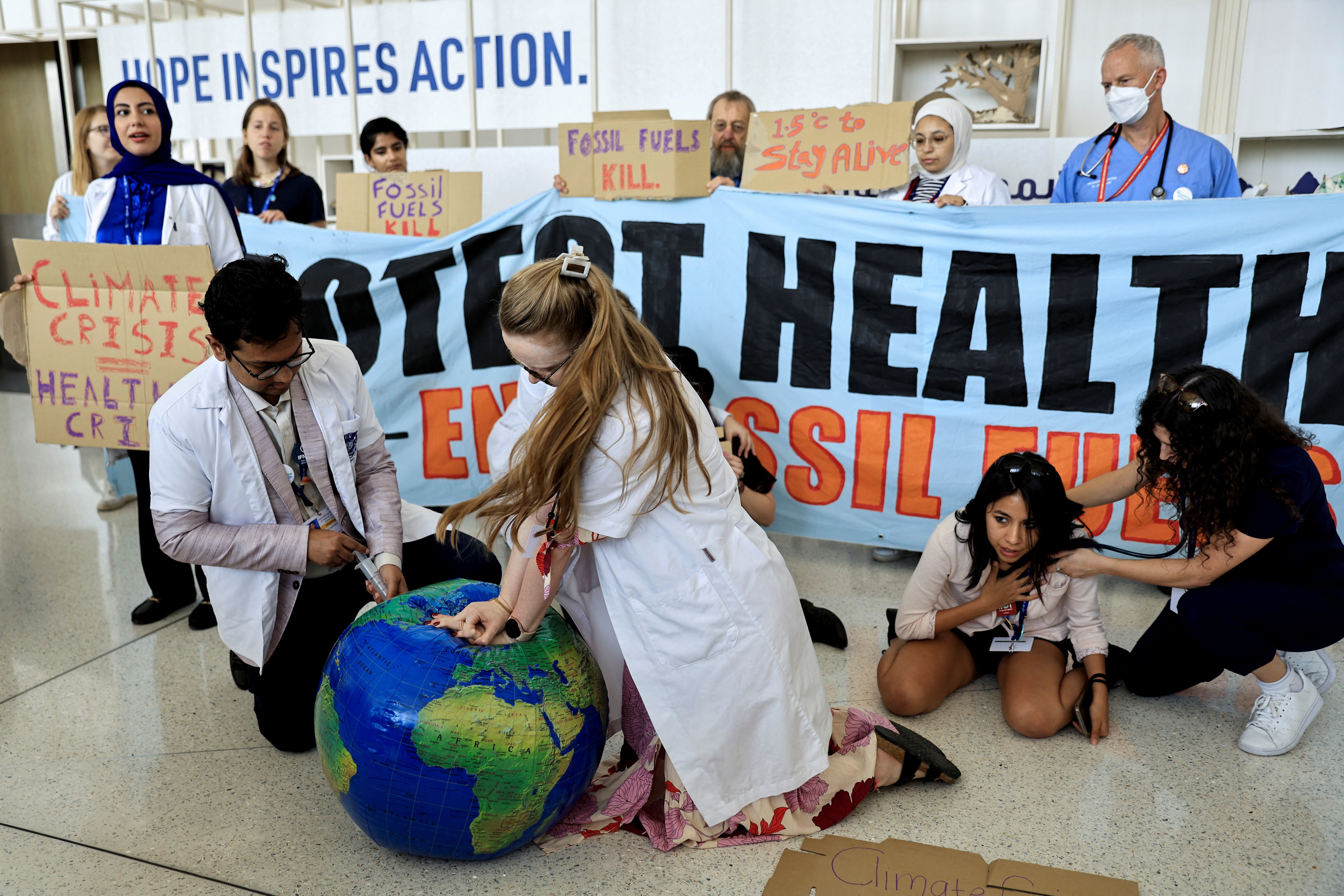 Members of the International Federation of Medical Students Associations hold protest demanding an end to fossil fuels at Cop28 climate summit, in Dubai