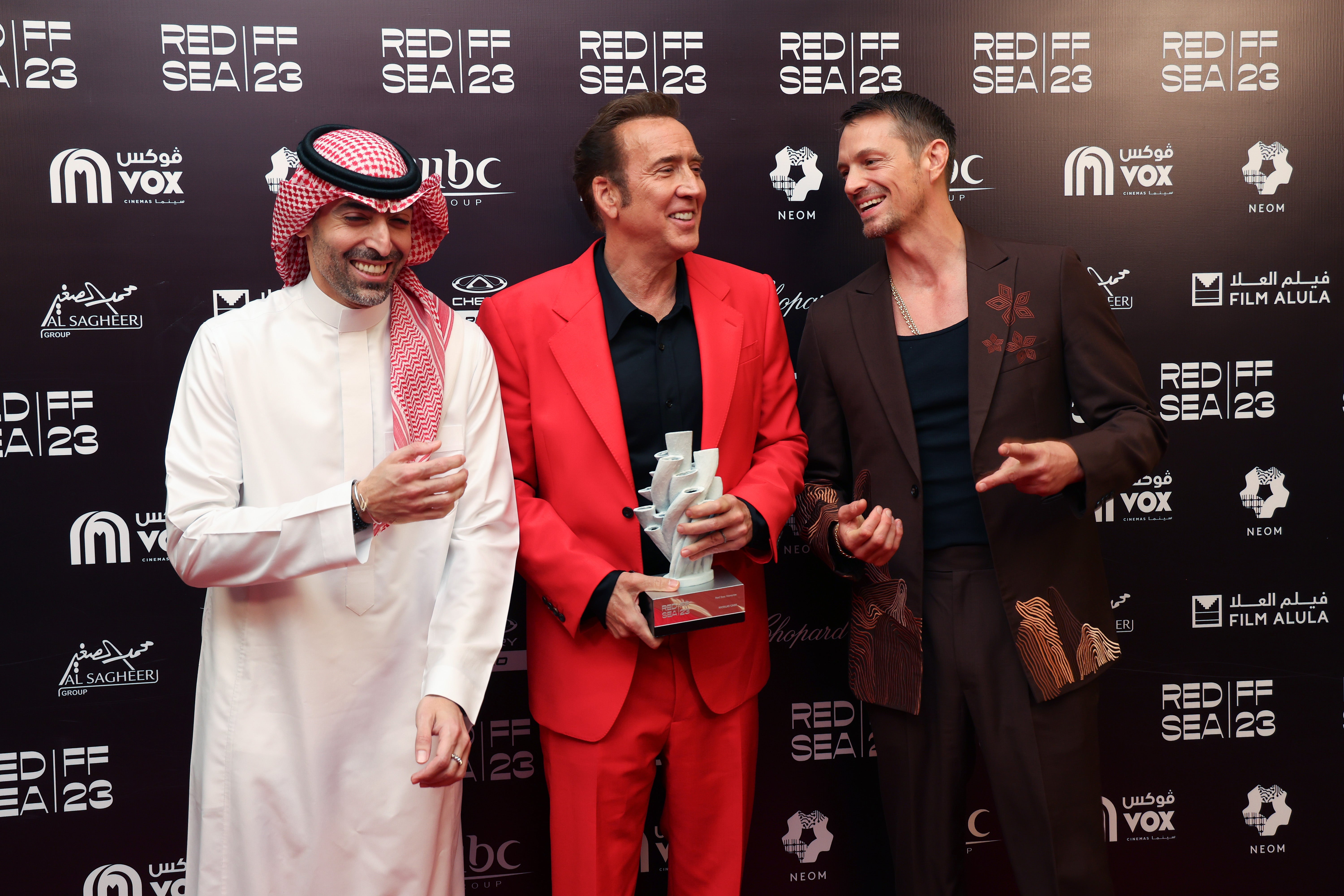 Mohammed Al Turki, Nicolas Cage and jury member Joel Kinnaman pose with the Honourary Award