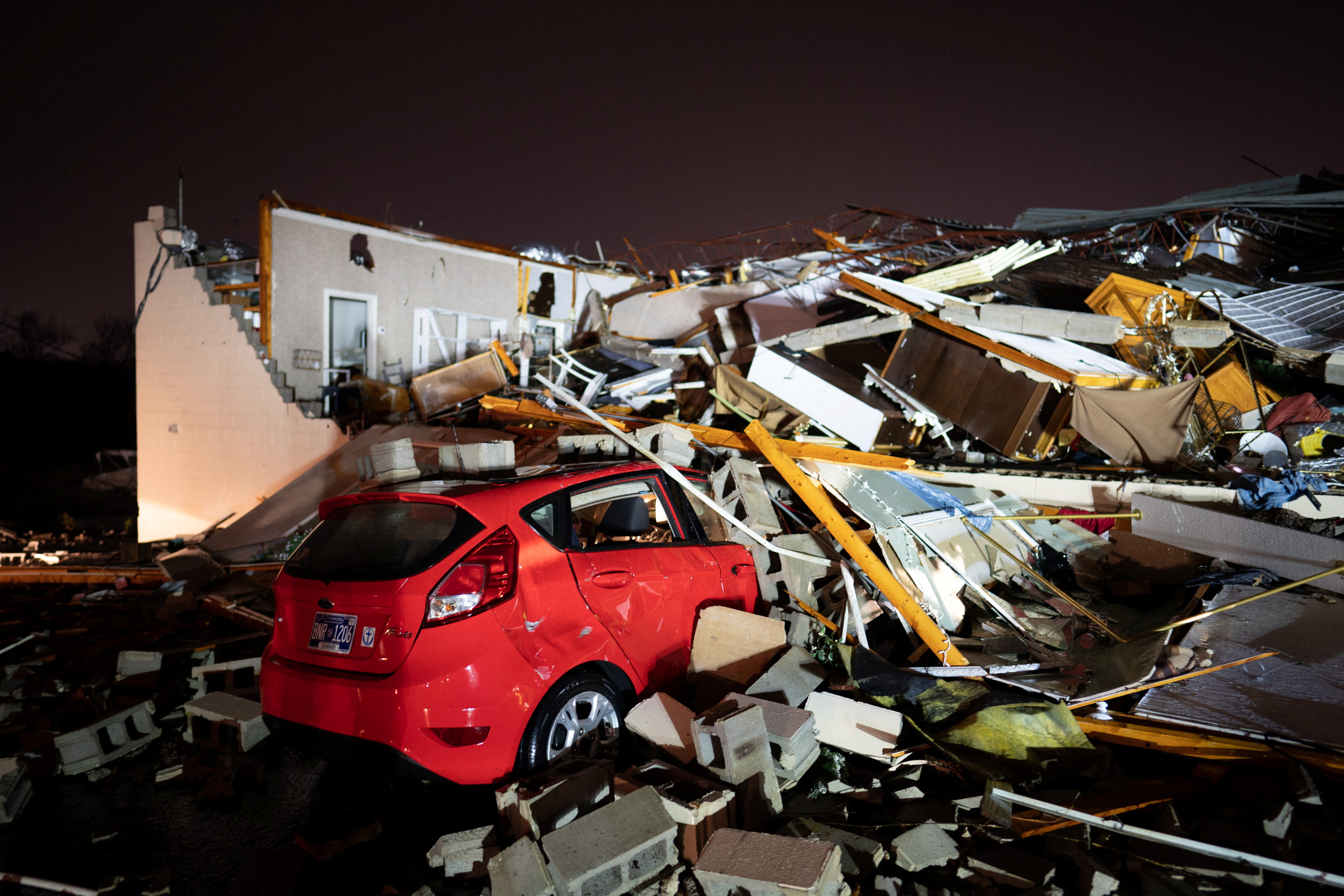 A car is buried under rubble on Main Street after a tornado hit Hendersonville, Tennessee, 9 December2023