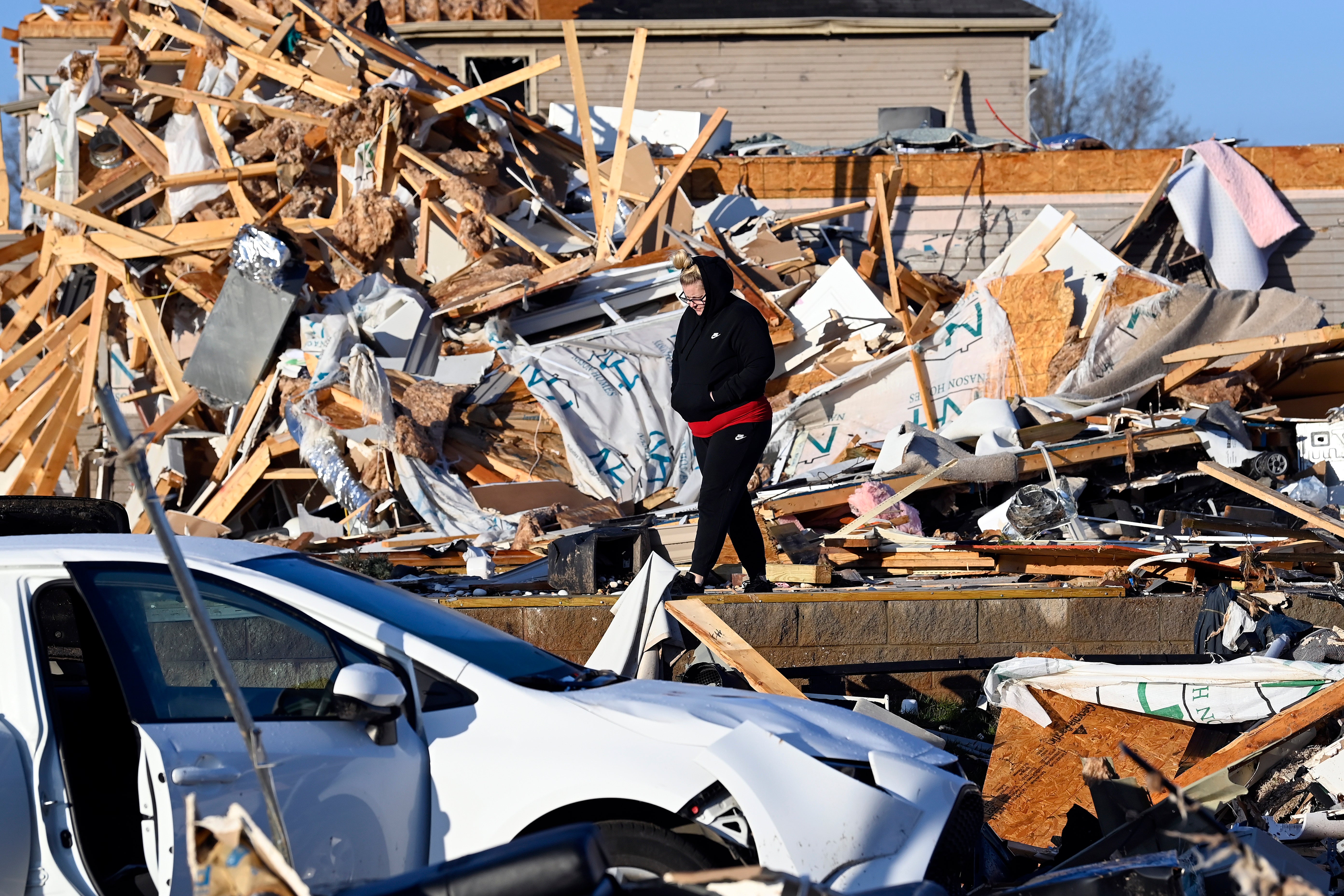 A resident examines the debris from a friend’s destroyed house in the West Creek Farms neighbourhood on Sunday, Dec. 10, 2023, Clarksville, Tenn.