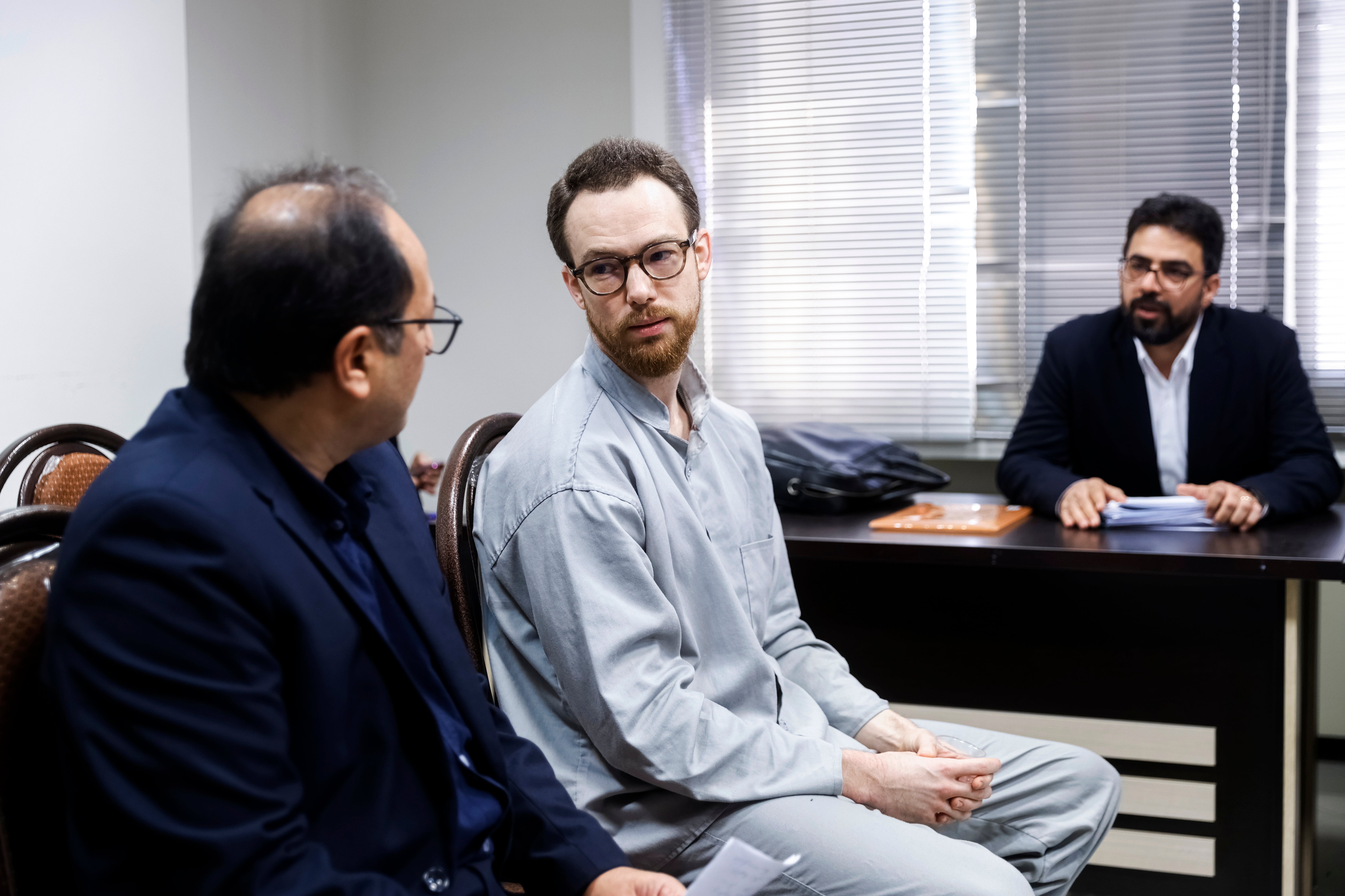 Swedish citizen Johan Floderus, center, sits at a courtroom at the Revolutionary Court in Tehran