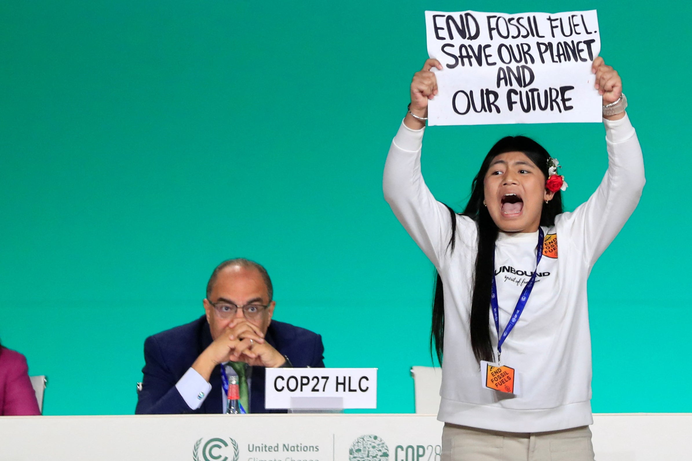 Licypriya Kangujam, an Indigenous climate activist from India, holds a banner about fossil fuels, the key issue at the summit