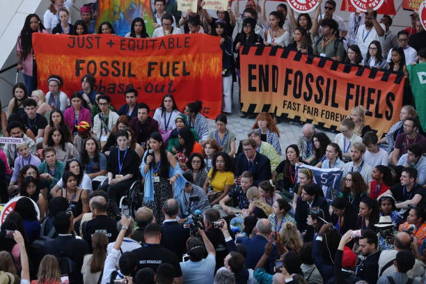 Climate activists protest to demand a phase out of fossil fuels on day twelve at the UNFCCC COP28 Climate Conference