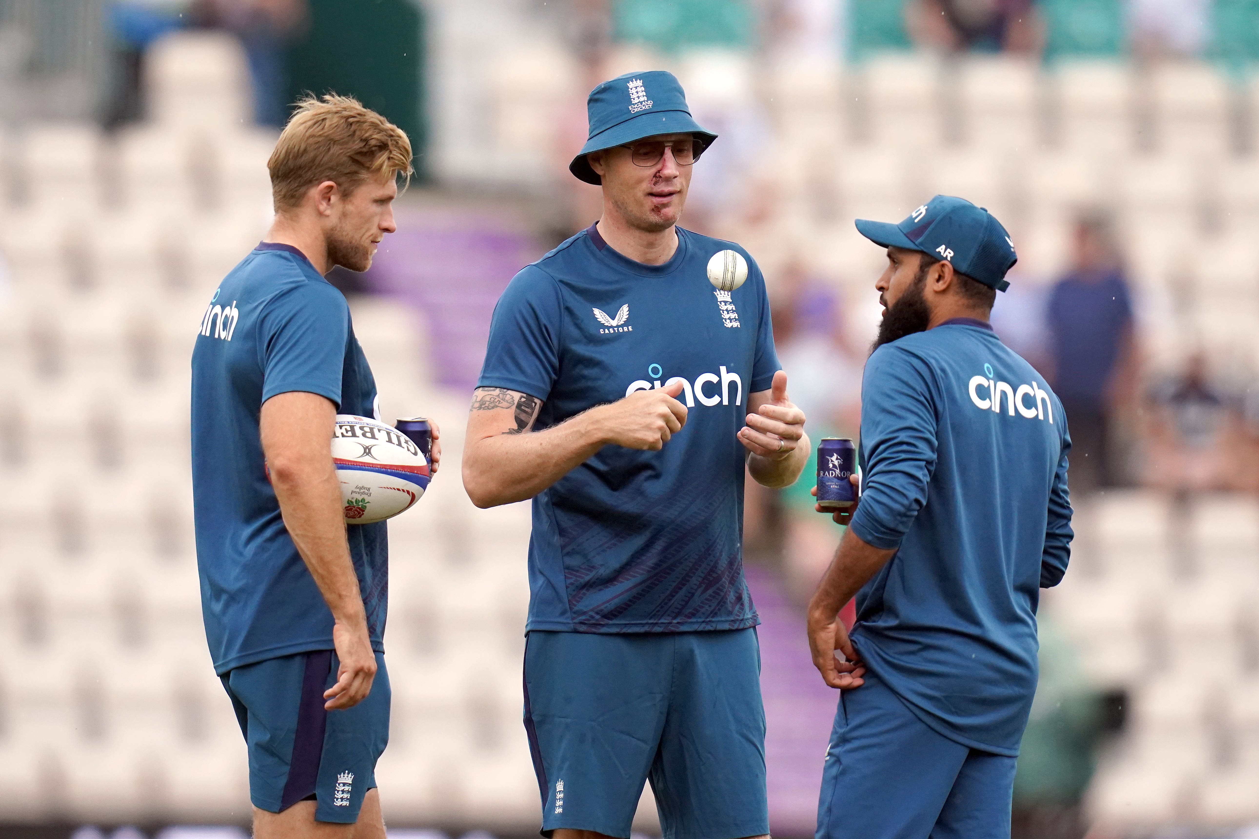 Andrew Flintoff, centre, gave Adil Rashid his cap to mark his 100th T20 appearance for England (John Walton/PA)