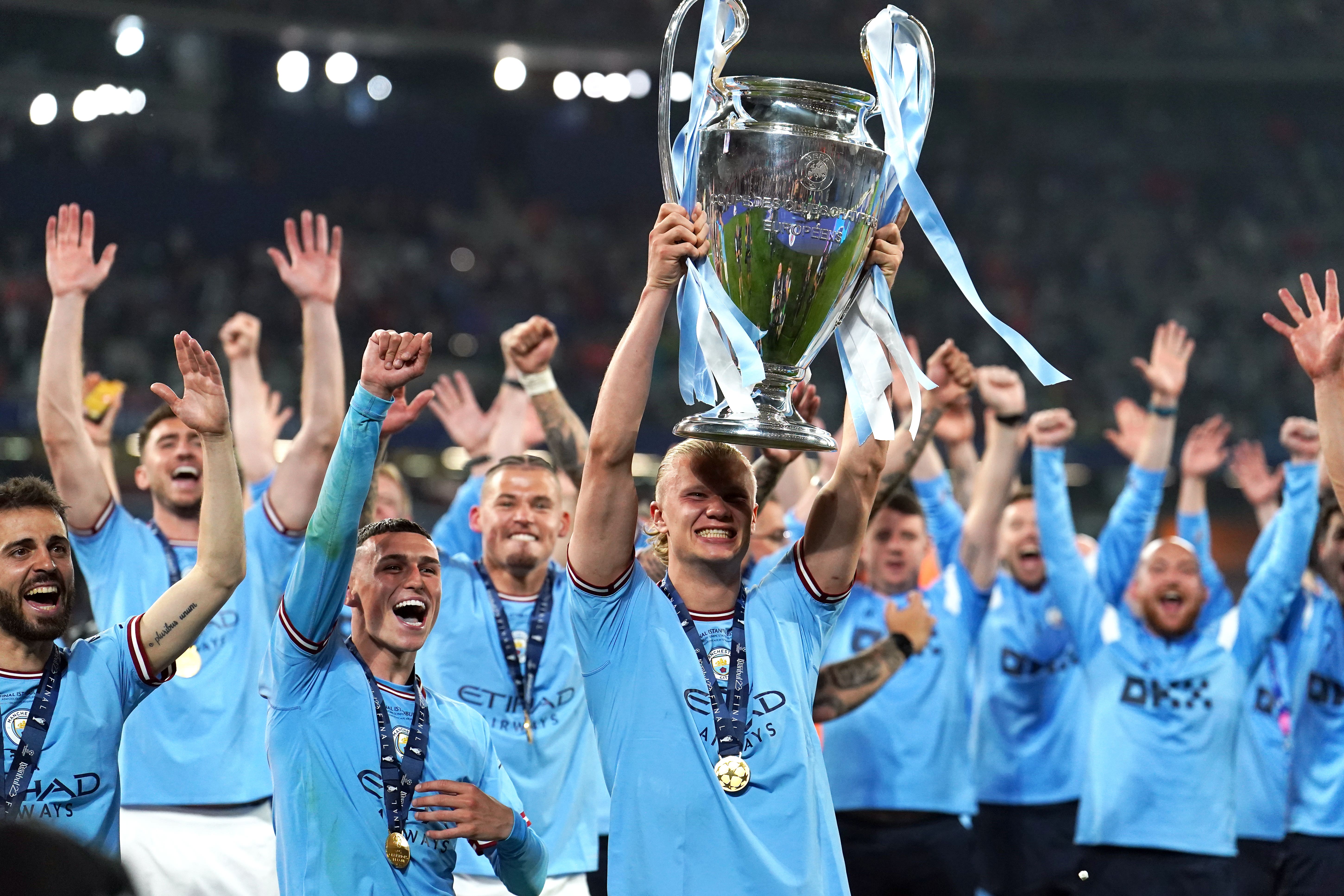 Erling Haaland holds aloft the Champions League trophy (Martin Rickett/PA)