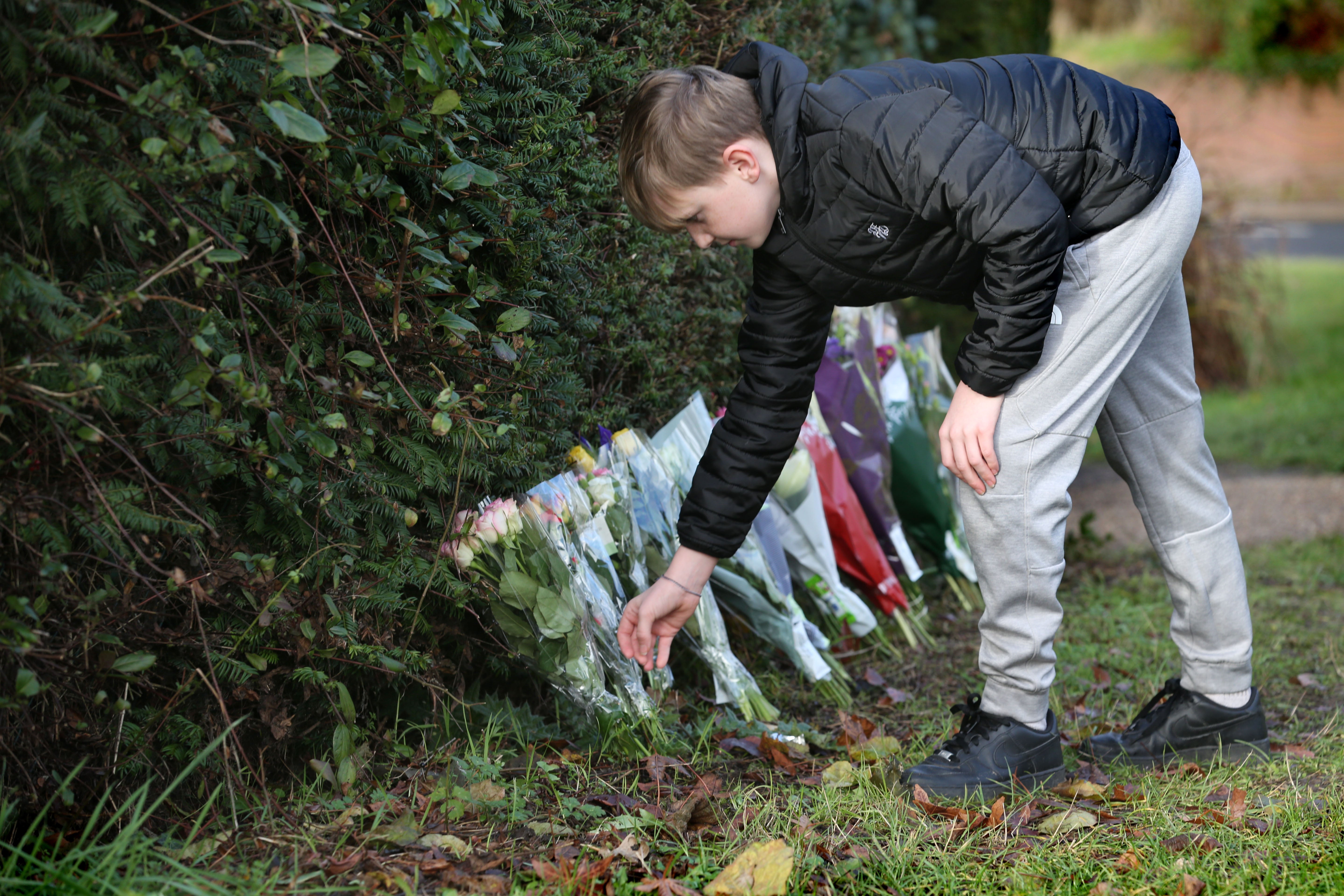 A young person leaves flowers for mother who disappeared