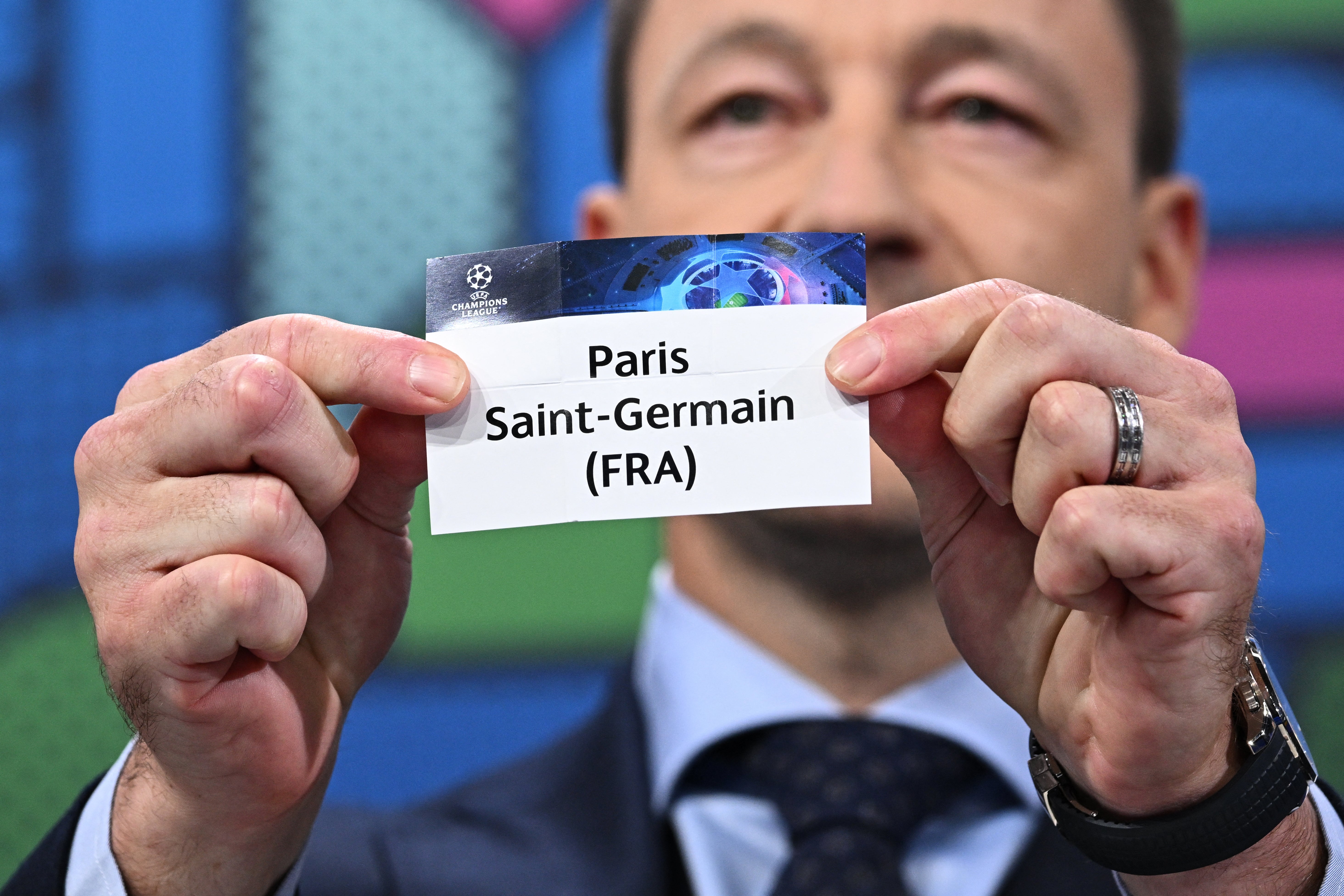 John Terry holds the paper slip of Paris Saint-Germain at the Champions League last 16 draw